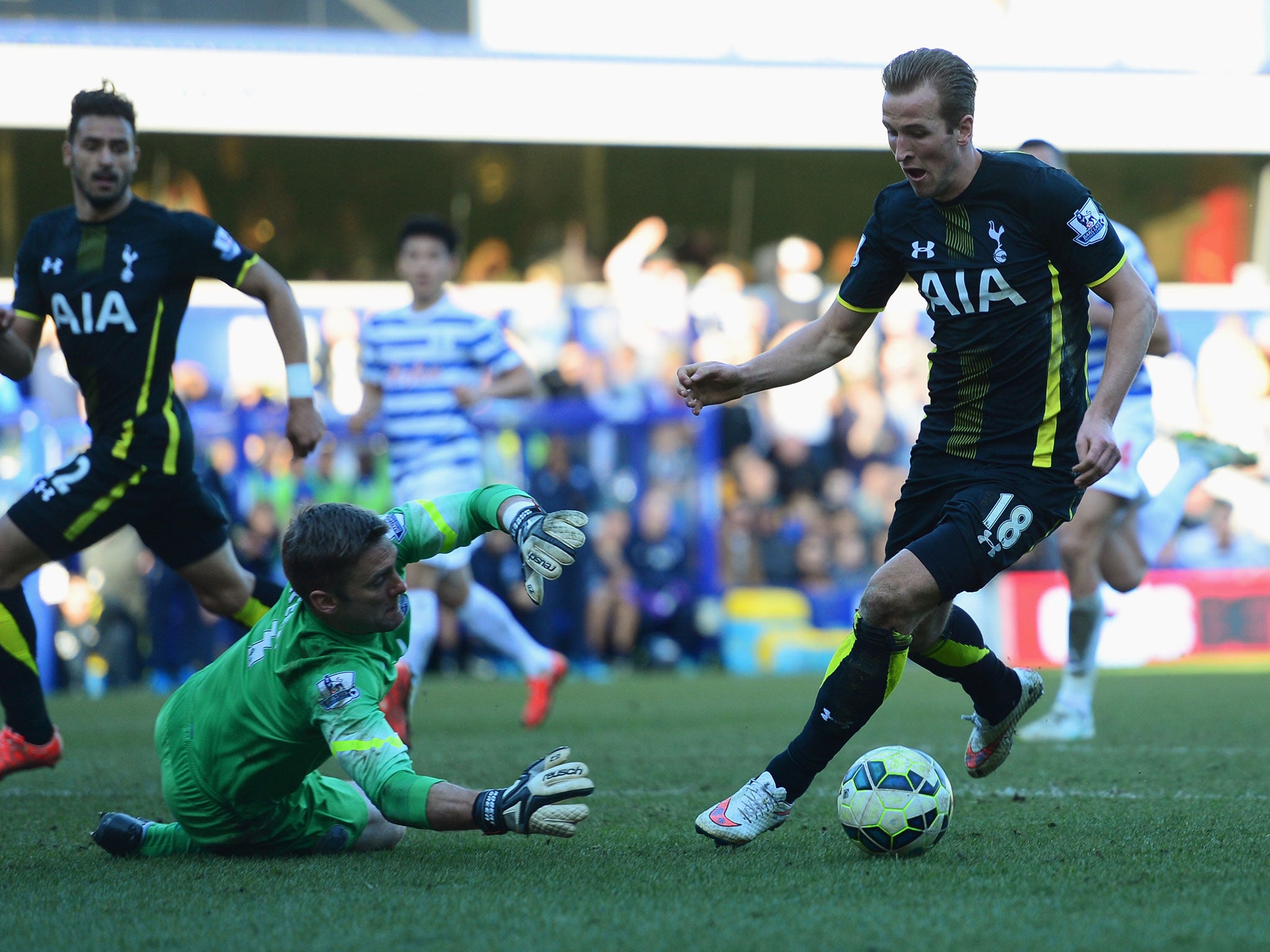 Harry Kane takes the ball around Robert Green to score his second