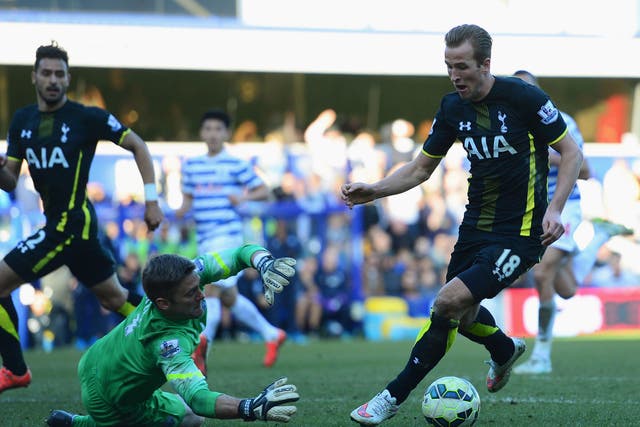 Harry Kane takes the ball around Robert Green to score his second