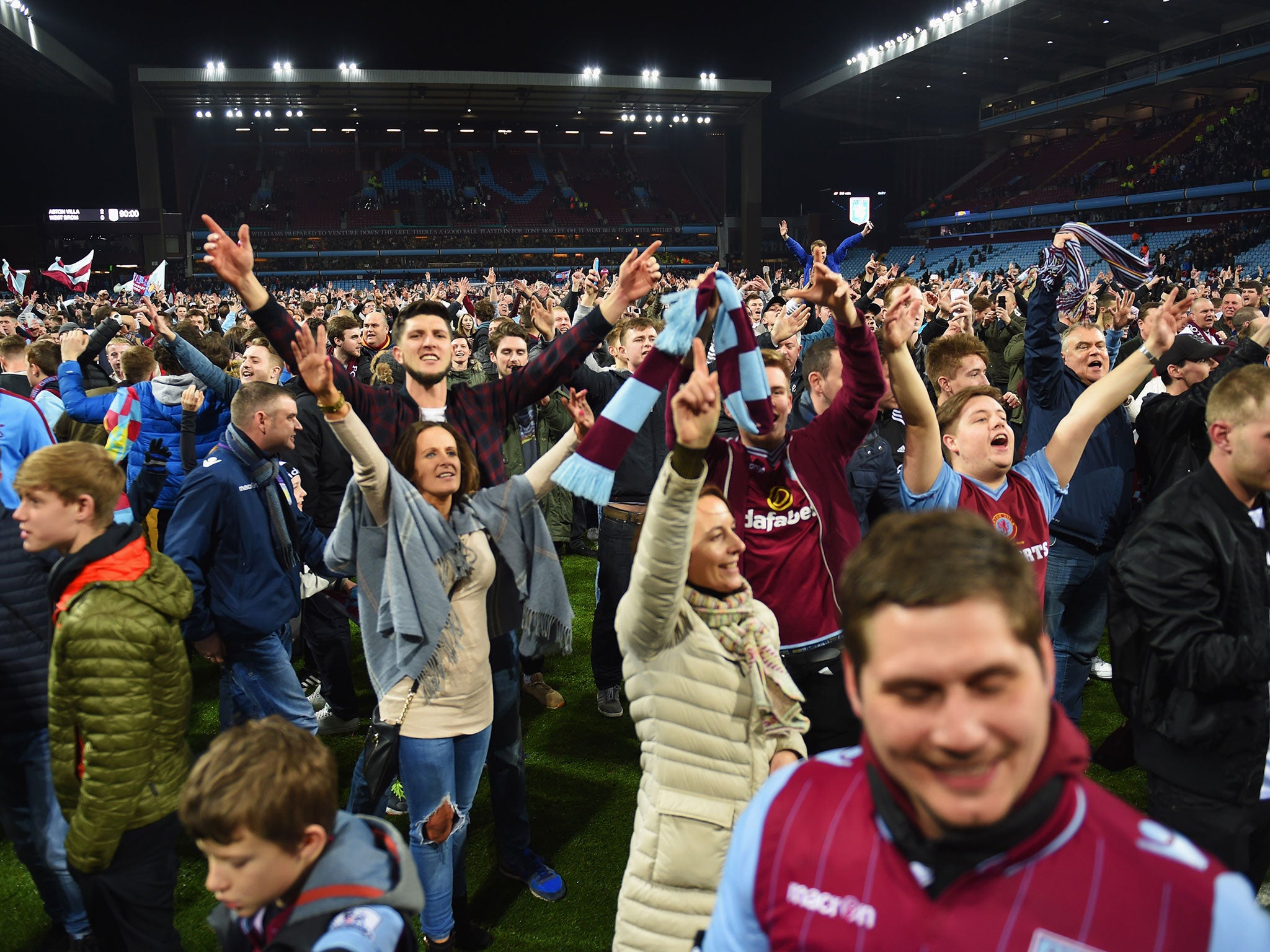 Aston Villa fans celebrate on the Villa Park pitch