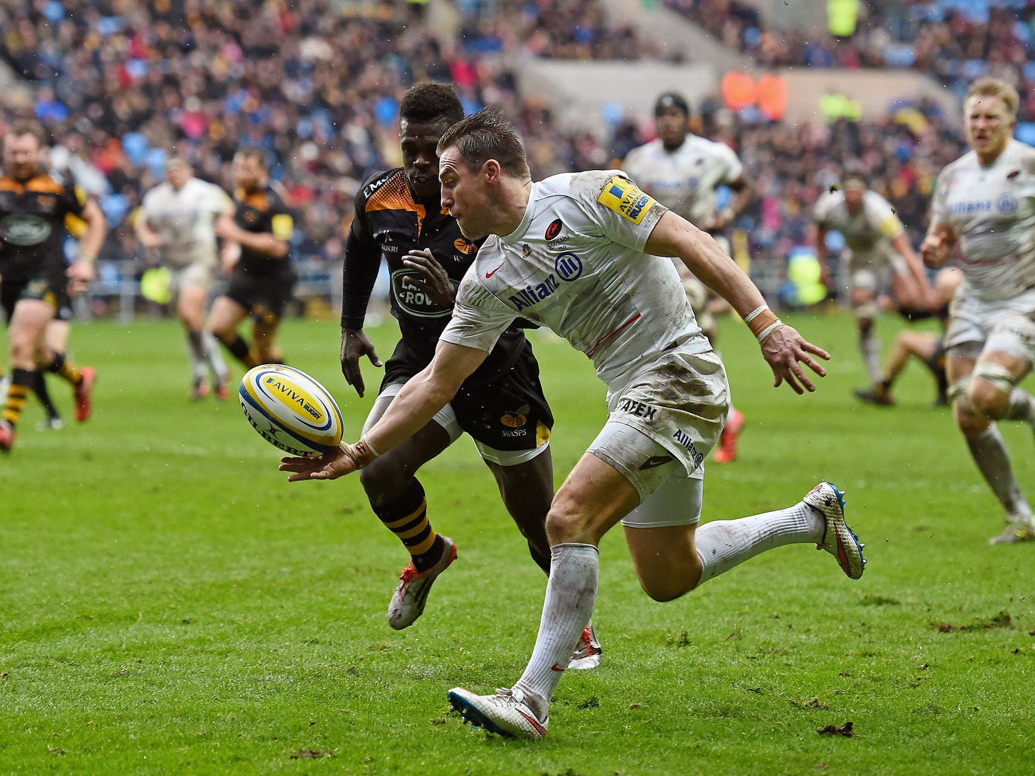 Chris Wyles of Saracens gathers the loose ball ahead of Christian Wade of Wasps en route to scoring his team's second try
