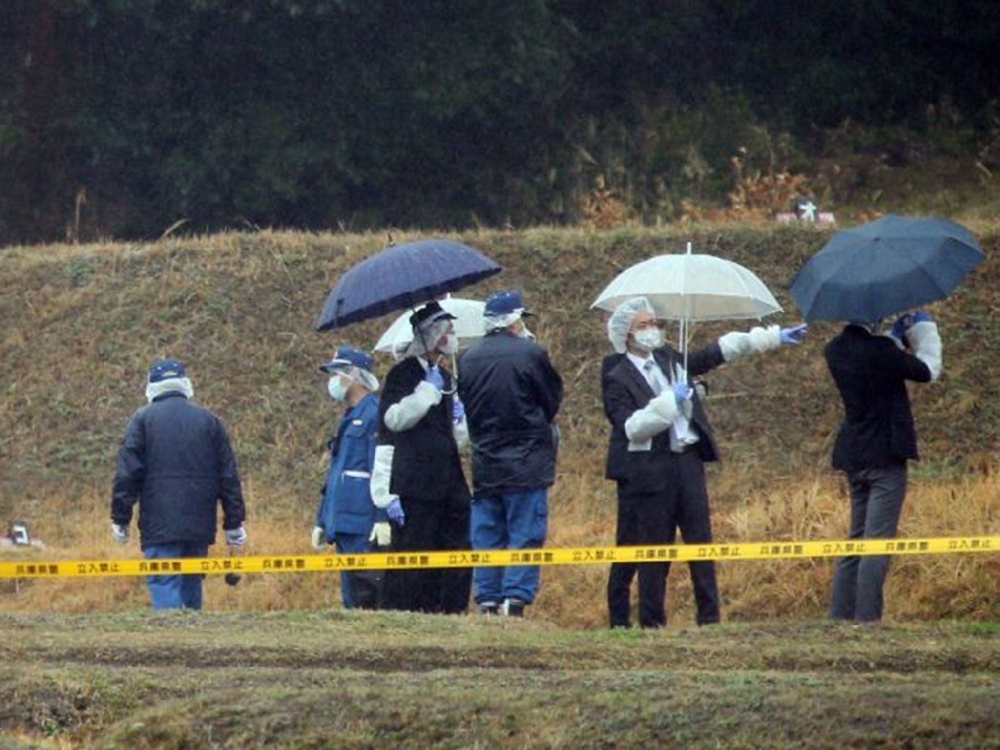 Police officers near houses where a man stabbed five people to death at Sumoto city in Awajishima island, Japan on March 9, 2015.