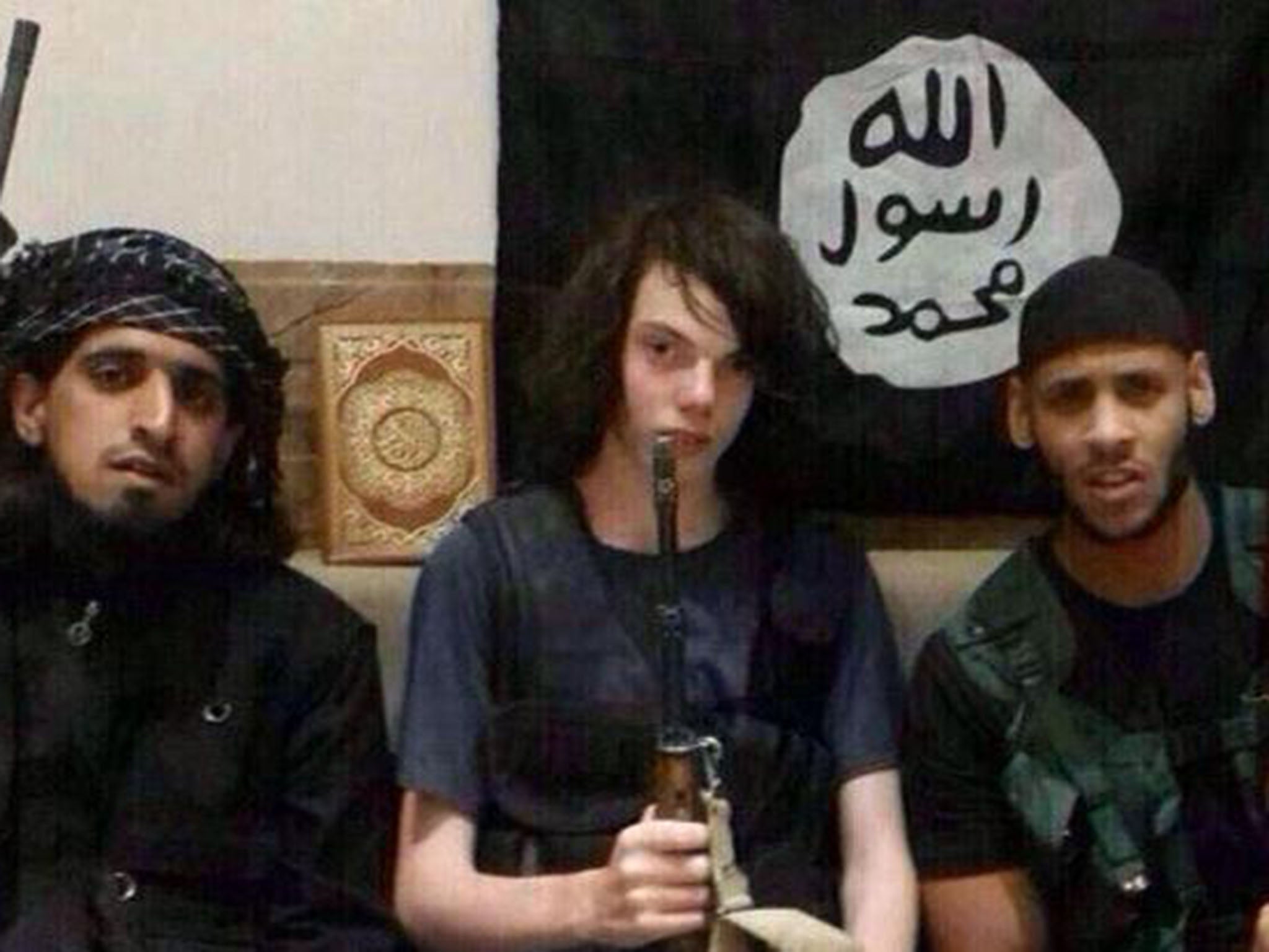 Jake (centre) sits between two men believed to be Islamic State fighters