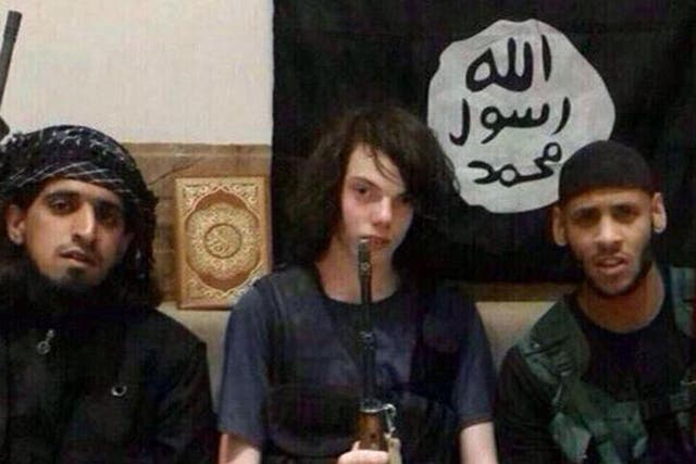 Jake (centre) sits between two men believed to be Islamic State fighters