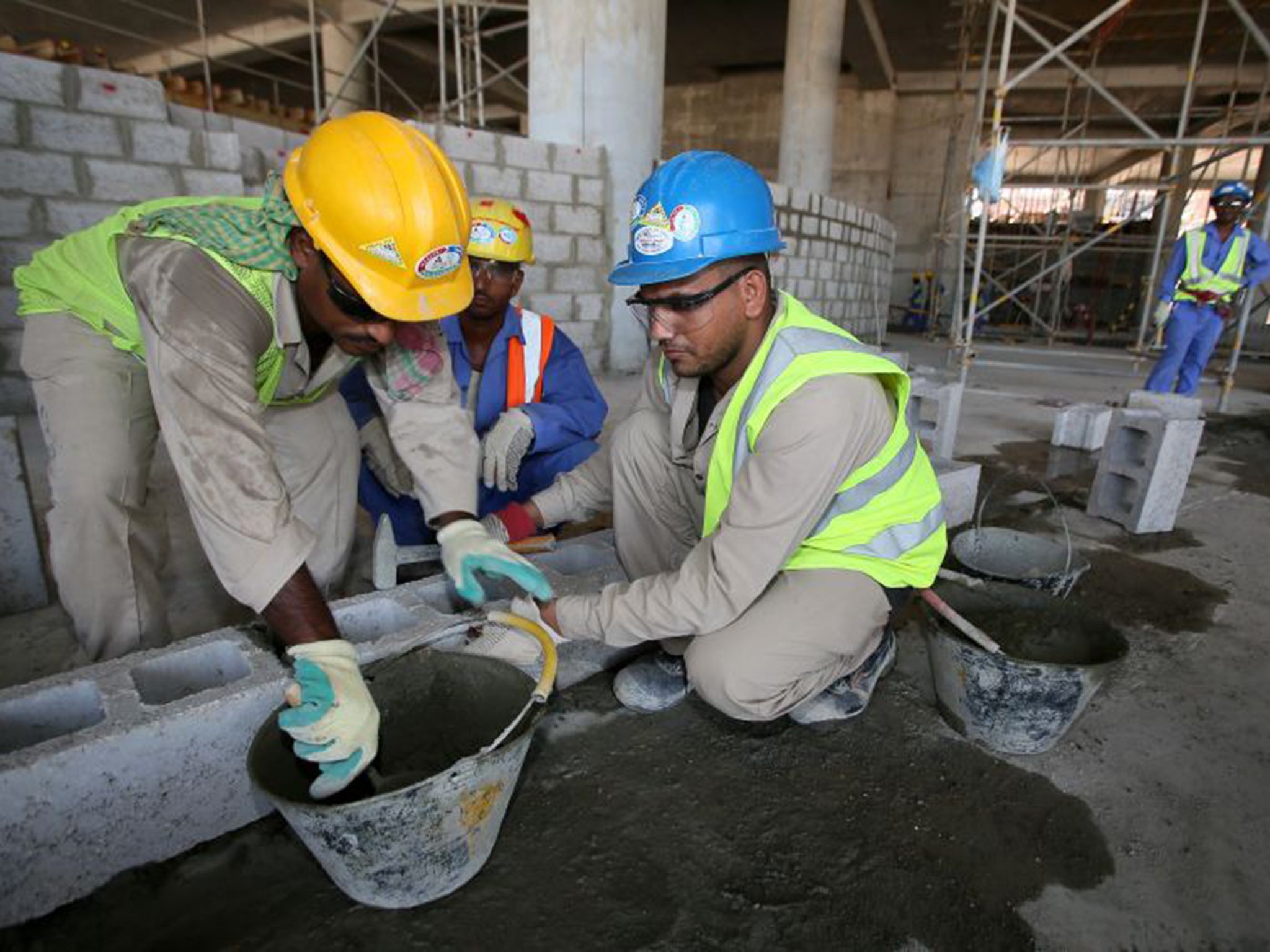Migrant labourers work on a construction site in Doha in Qatar. Widespread abuses of migrant workers have been documented since the country was chosen to host the 2022 World Cup