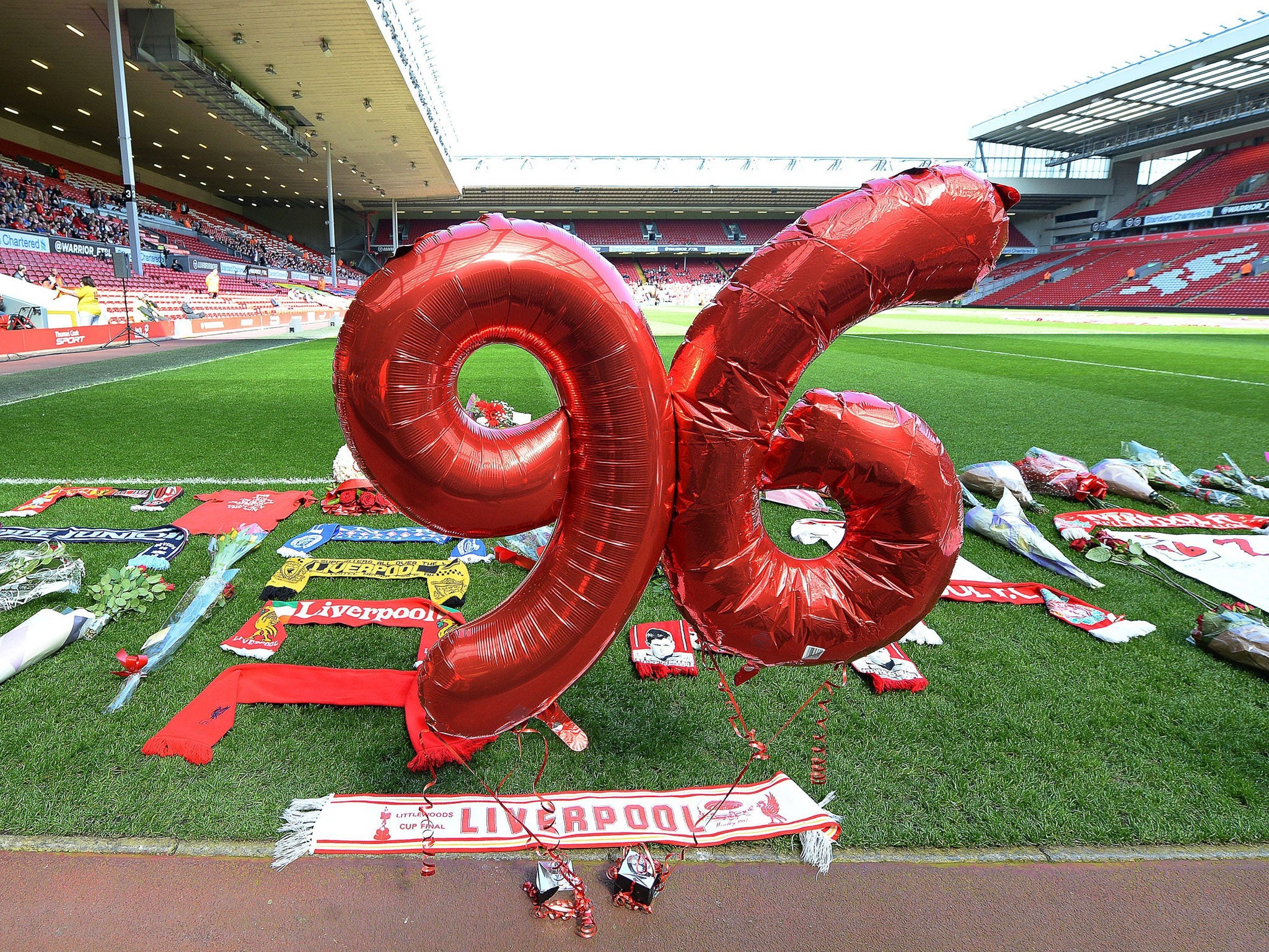 Scarfs and balloons are placed in front of the Kop stand on the Anfield pitch to mark the 25th anniversary of the Hillsborough disaster in Liverpool in April last year