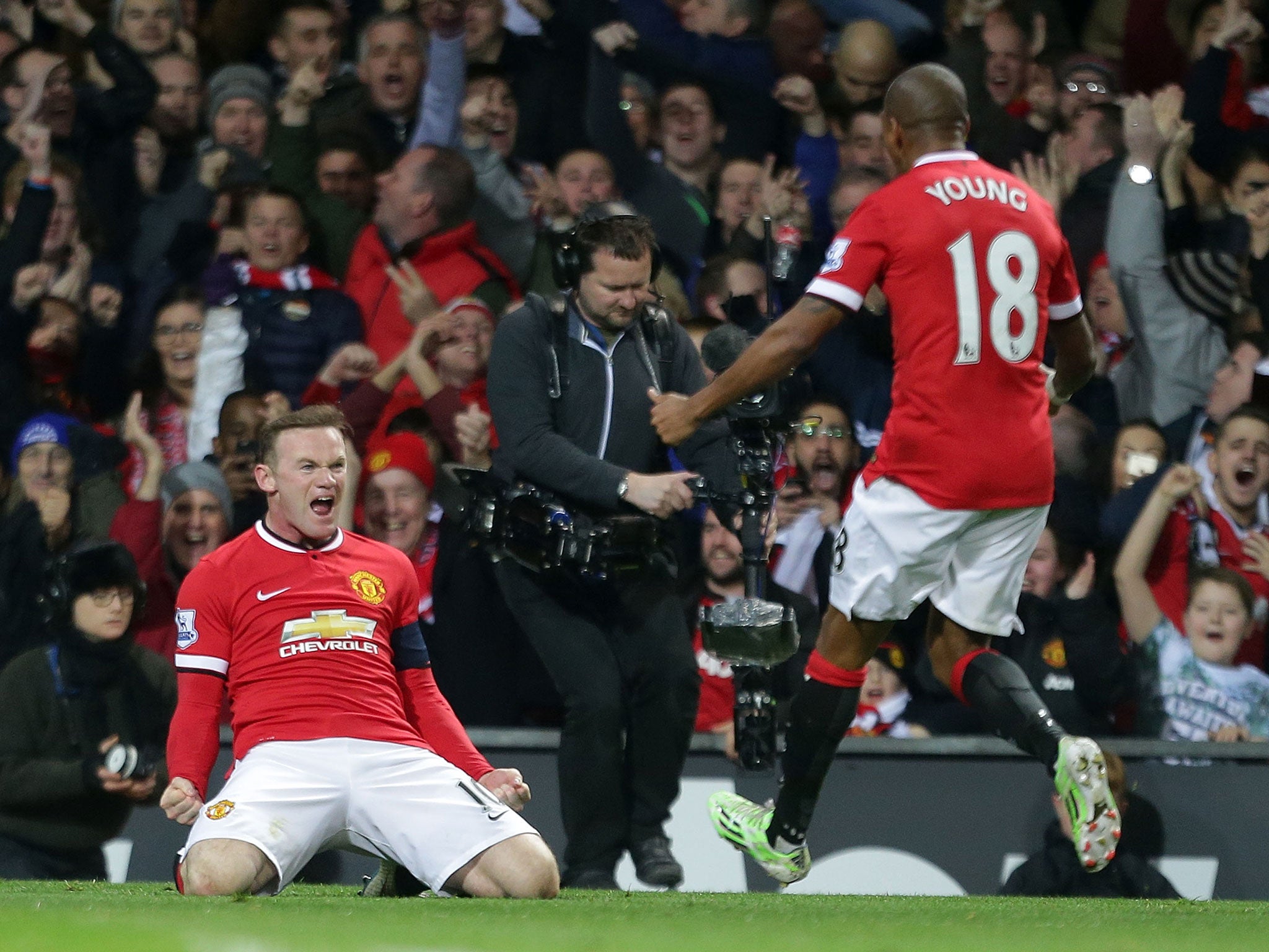 Rooney celebrates with Young after equalising