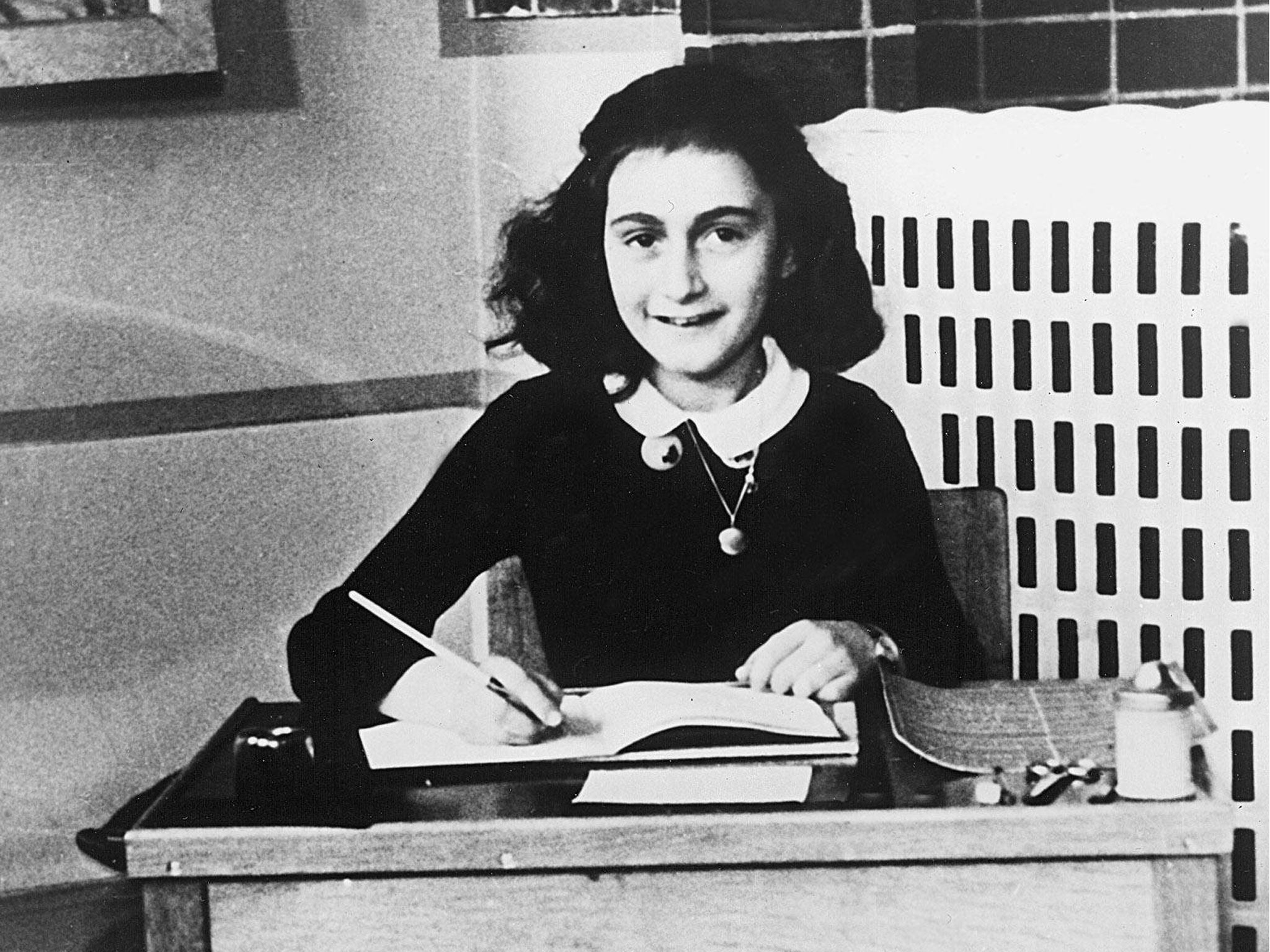 Anne Frank writing in her diary in the 1940s