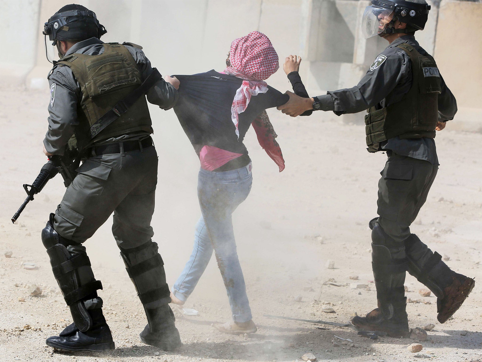 Israeli border guards detain a Palestinian protester during clashes following a demonstration against the incarceration of Palestinian university students, near Ramallah
