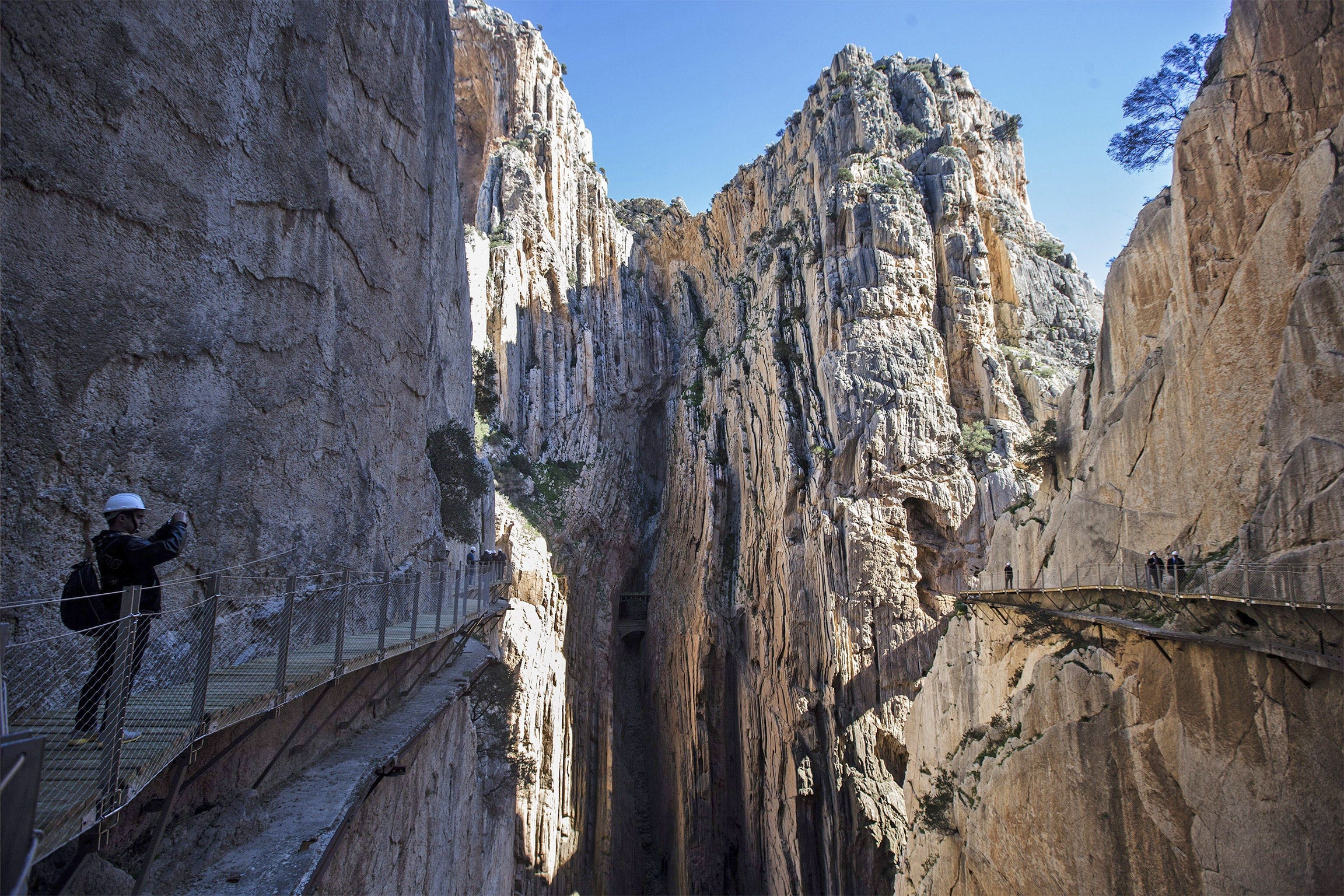 Journalists walk on the 'Caminito del Rey' (the King's little pathway) at the Gaitanes gorge at the Guadalhorce river in Malaga