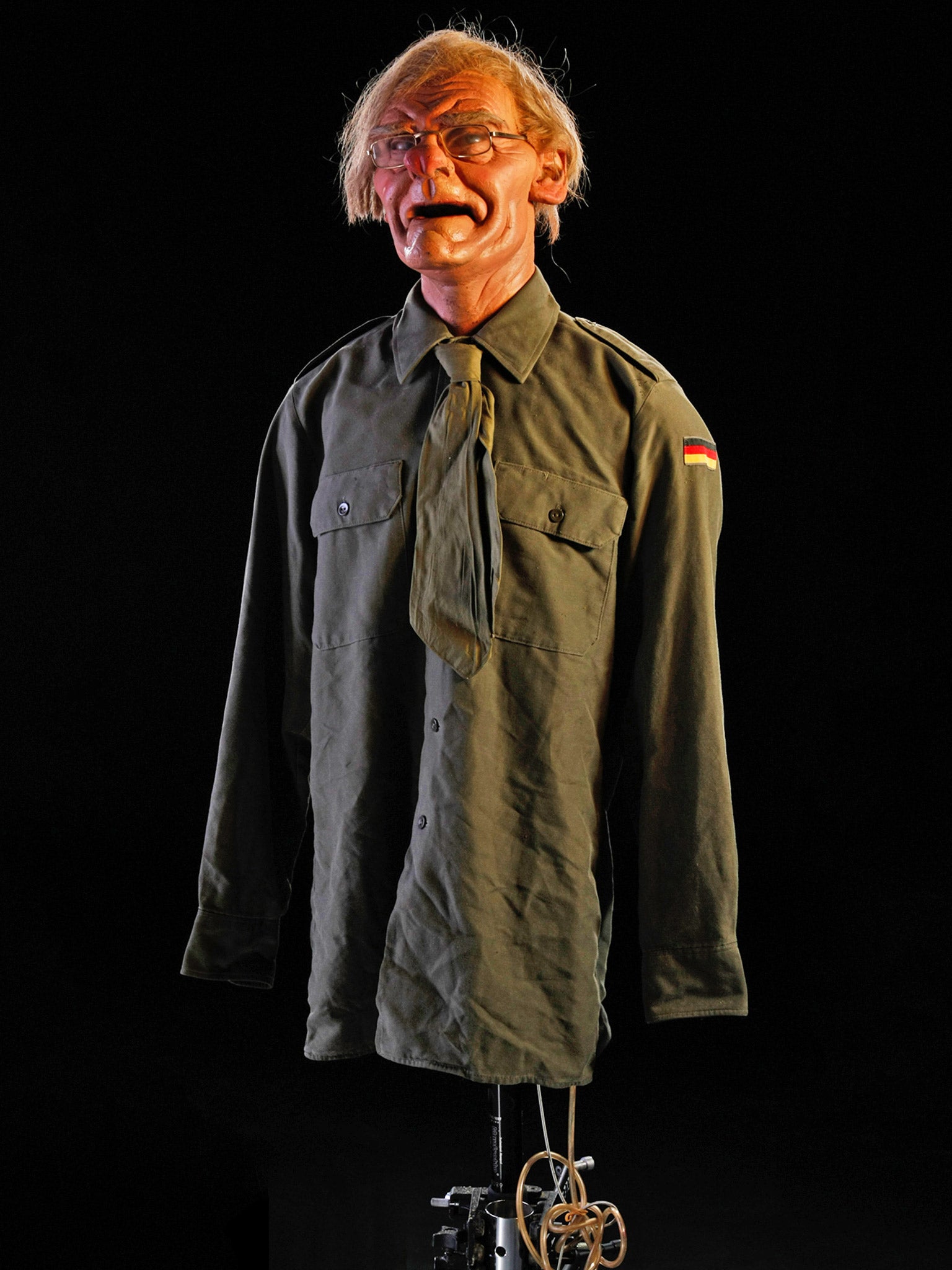 Michael Heseltine is perched on a stand wearing his German army shirt costume (Andrew Bruce &amp; Anna Fox)