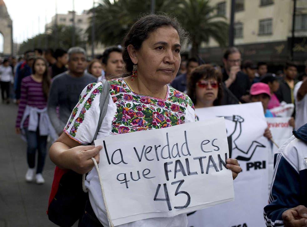 A woman walks the streets campaigning for one of the 43 disappeared teaching students