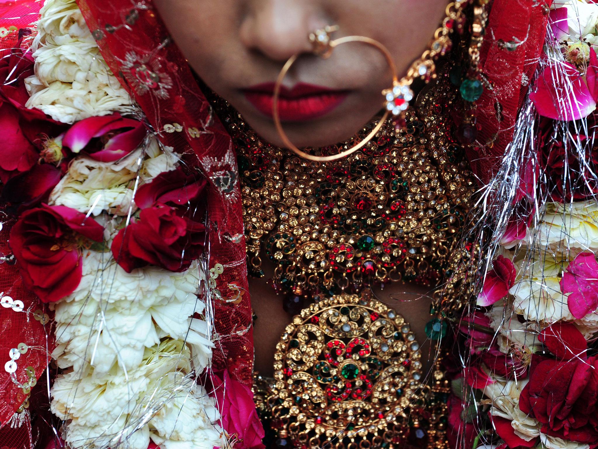 An Indian bride wears decorations during a wedding ceremony