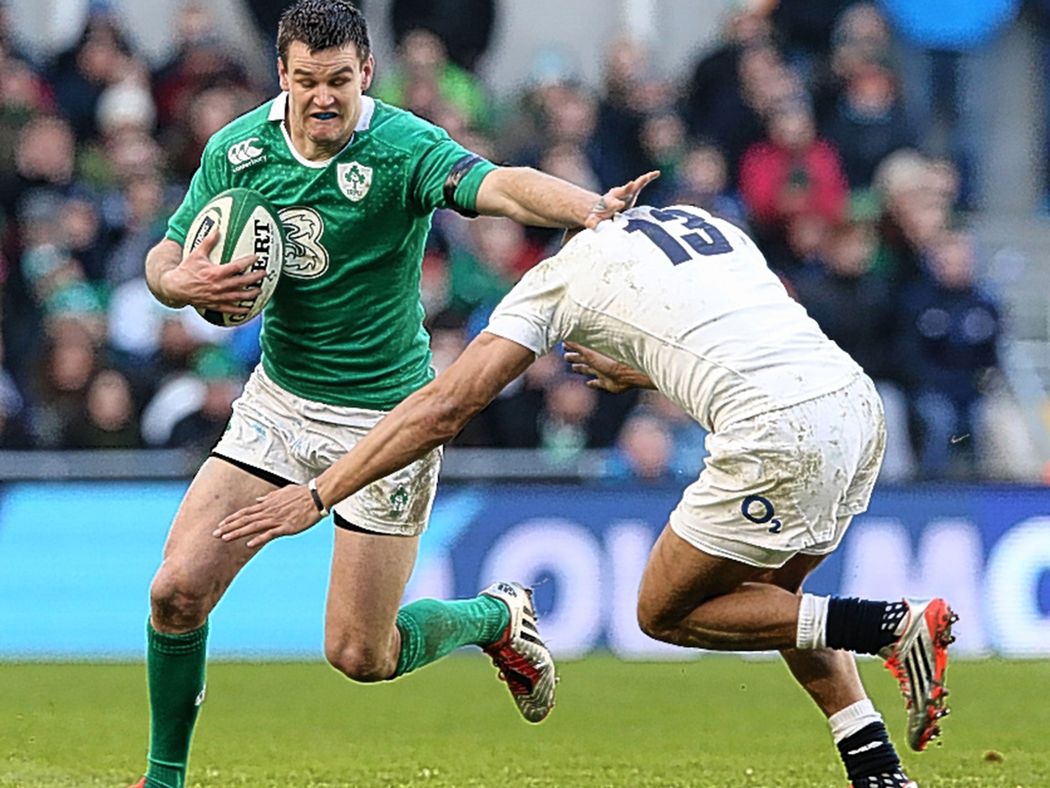 Jonny Sexton fends off a challenge against England. The Irishman is vulnerable when forced to tackle