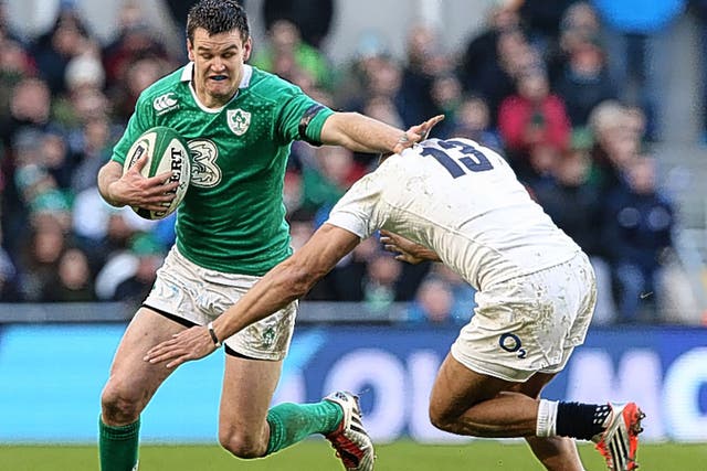 Jonny Sexton fends off a challenge against England. The Irishman is vulnerable when forced to tackle