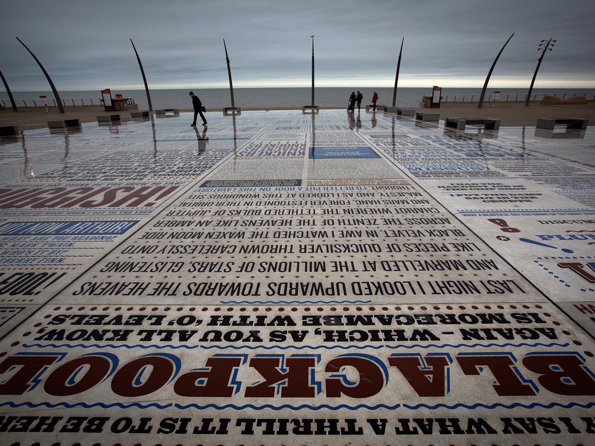 Visitors walking past Gordon Young’s ‘Comedy Carpet’ artwork in Blackpool