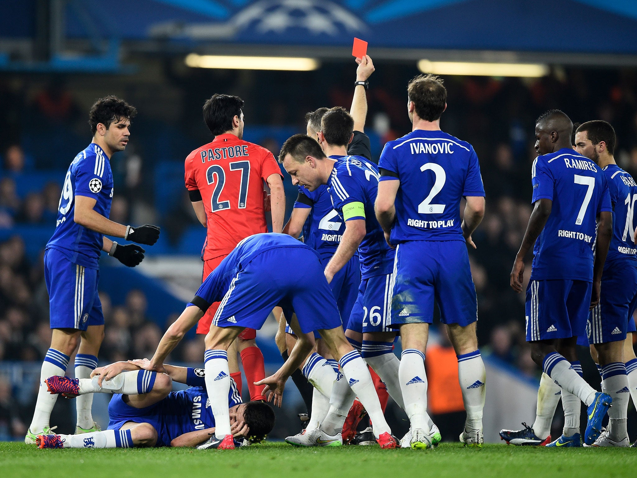 Chelsea players hound referee Bjorn Kuipers during their match with PSG