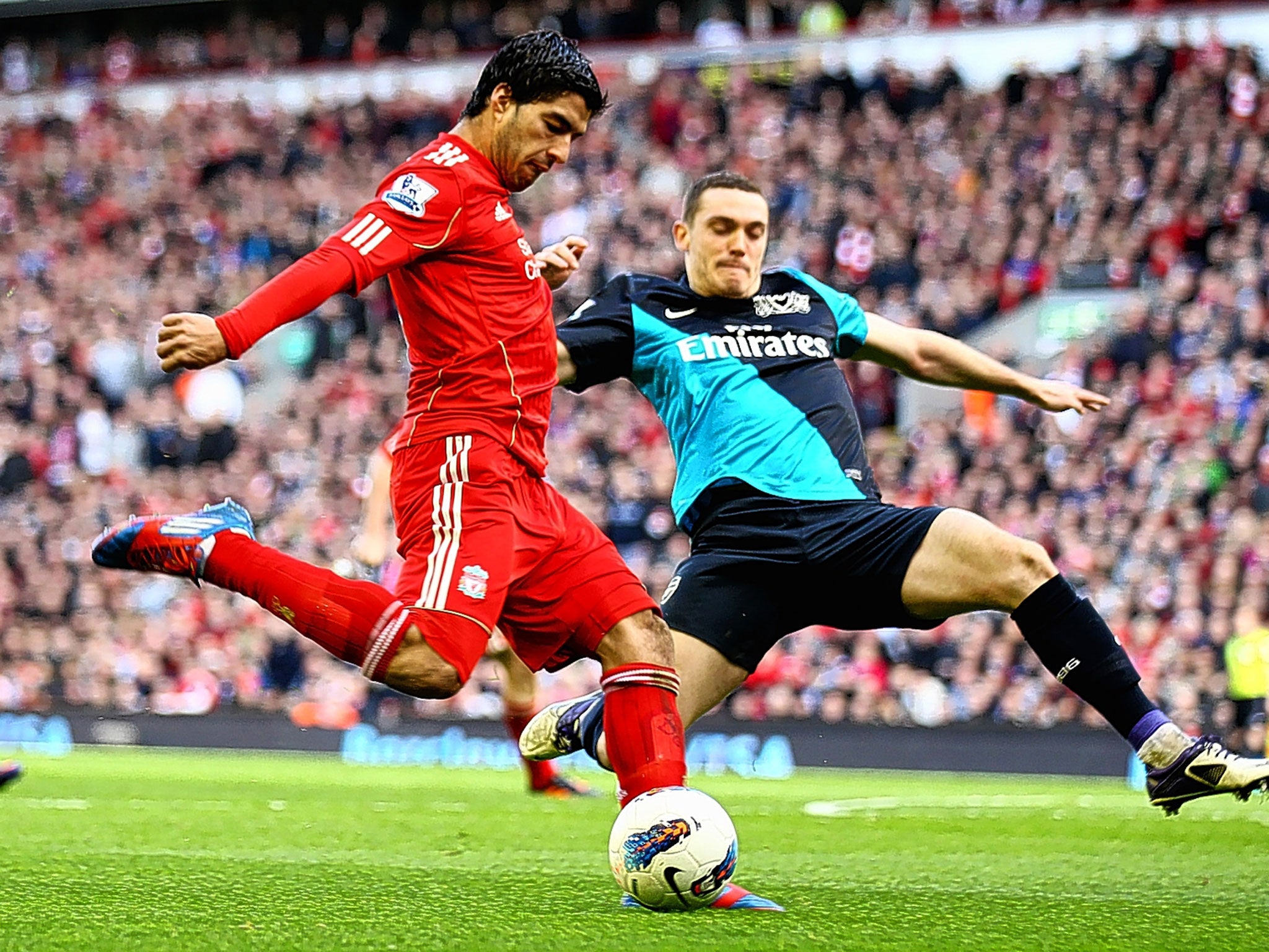 Luis Suarez (left) playing for Liverpool against Arsenal in 2012. The confusion over Arsenal’s move for him a year later arose from a misreading of his complex contract