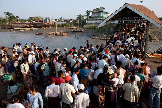 Burmese passengers disembark from a ferry heading home during rush hour on 1 May, 2009