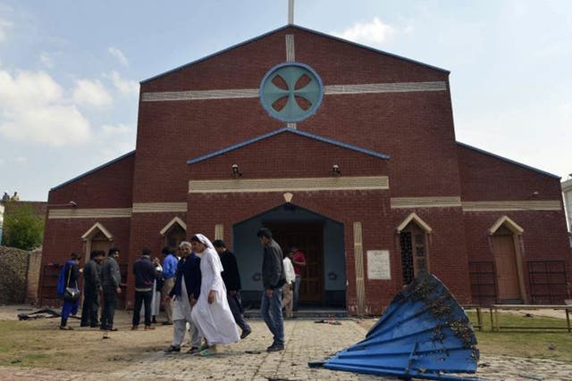 akistani Christians gather in front of a church following suicide bombing attacks on churches in Lahore on March 15, 2015. Eight people were killed and more than 50 injured when two Taliban suicide bombers attacked churches in Pakistan, sparking mob viole