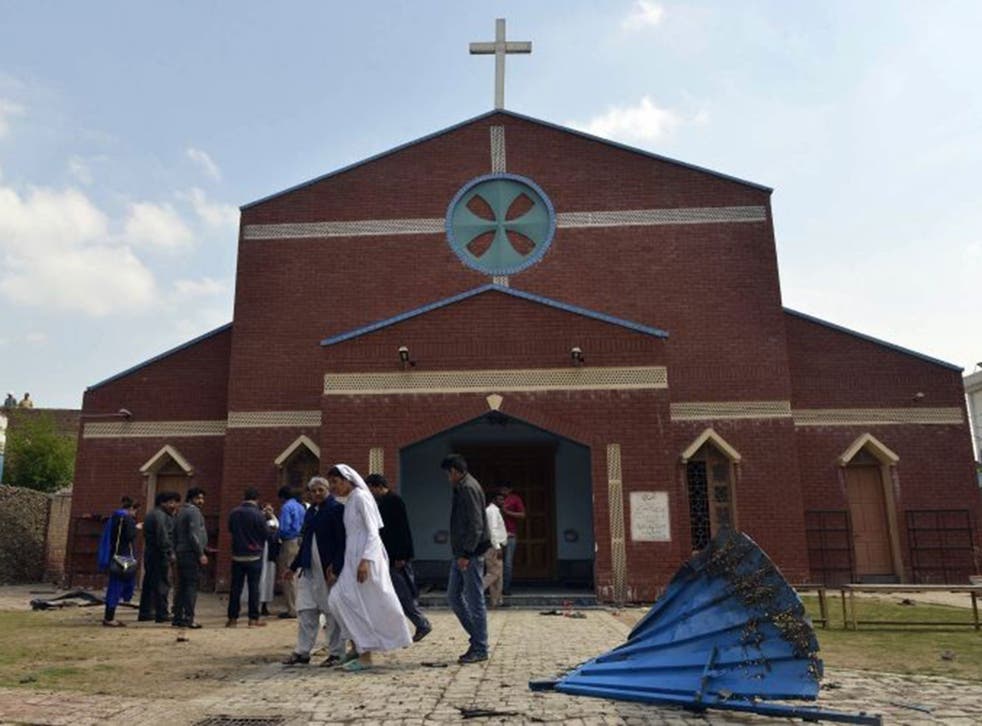 akistani Christians gather in front of a church following suicide bombing attacks on churches in Lahore on March 15, 2015. Eight people were killed and more than 50 injured when two Taliban suicide bombers attacked churches in Pakistan, sparking mob viole