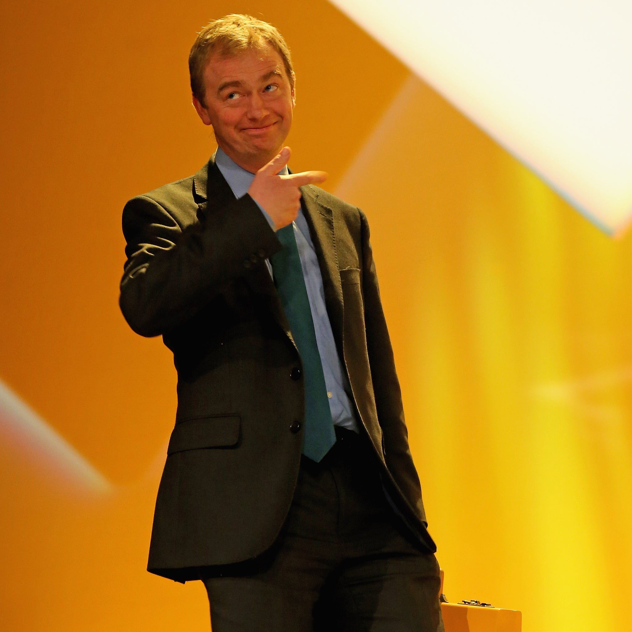 Tim Farron MP carries the Lib DEm 'budget box' on to the stage during the party's spring conference at the ACC on March 15, 2015 in Liverpool, England.