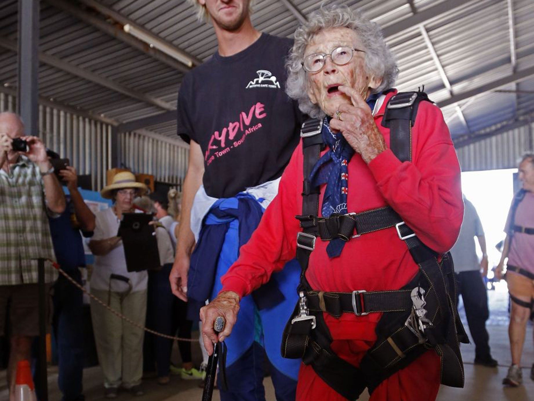 Centenarian Georgina Harwood, foreground, prepares with Jason Baker, for her tandem parachute jump forming part of her birthday celebrations