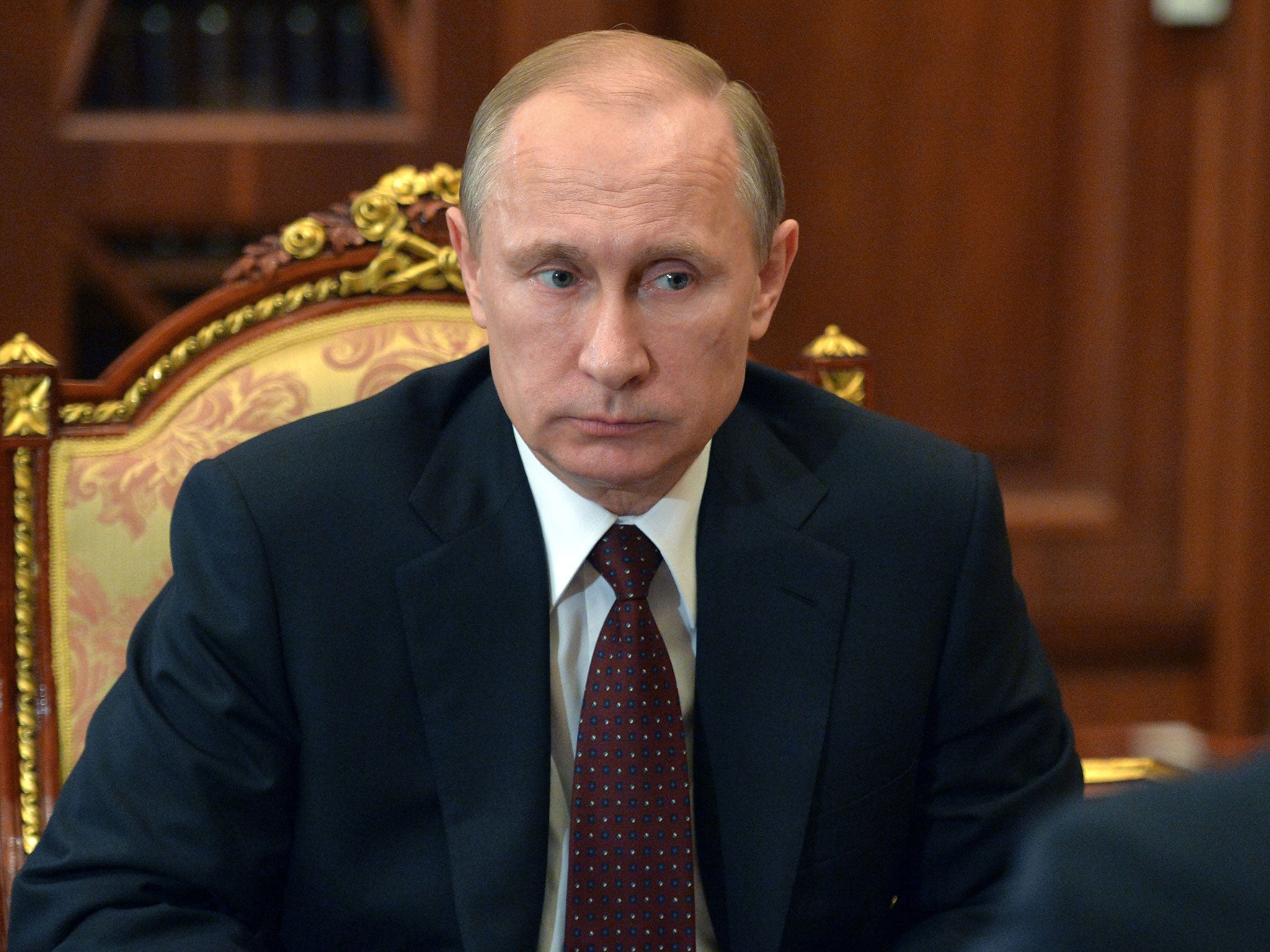 Russian President Vladimir Putin listens during a meeting at the Kremlin, in Moscow
