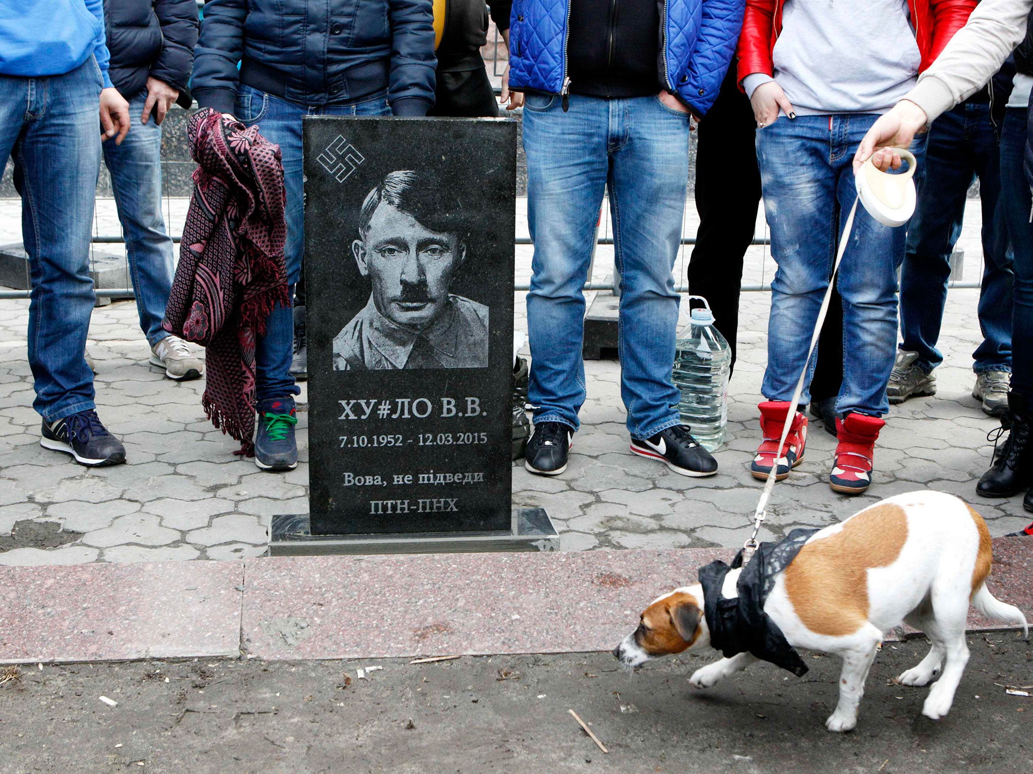A mock headstone depicting the Russian leader as Adolf Hitler during a 'Funeral of Putin' protest at the Russian embassy in Kiev