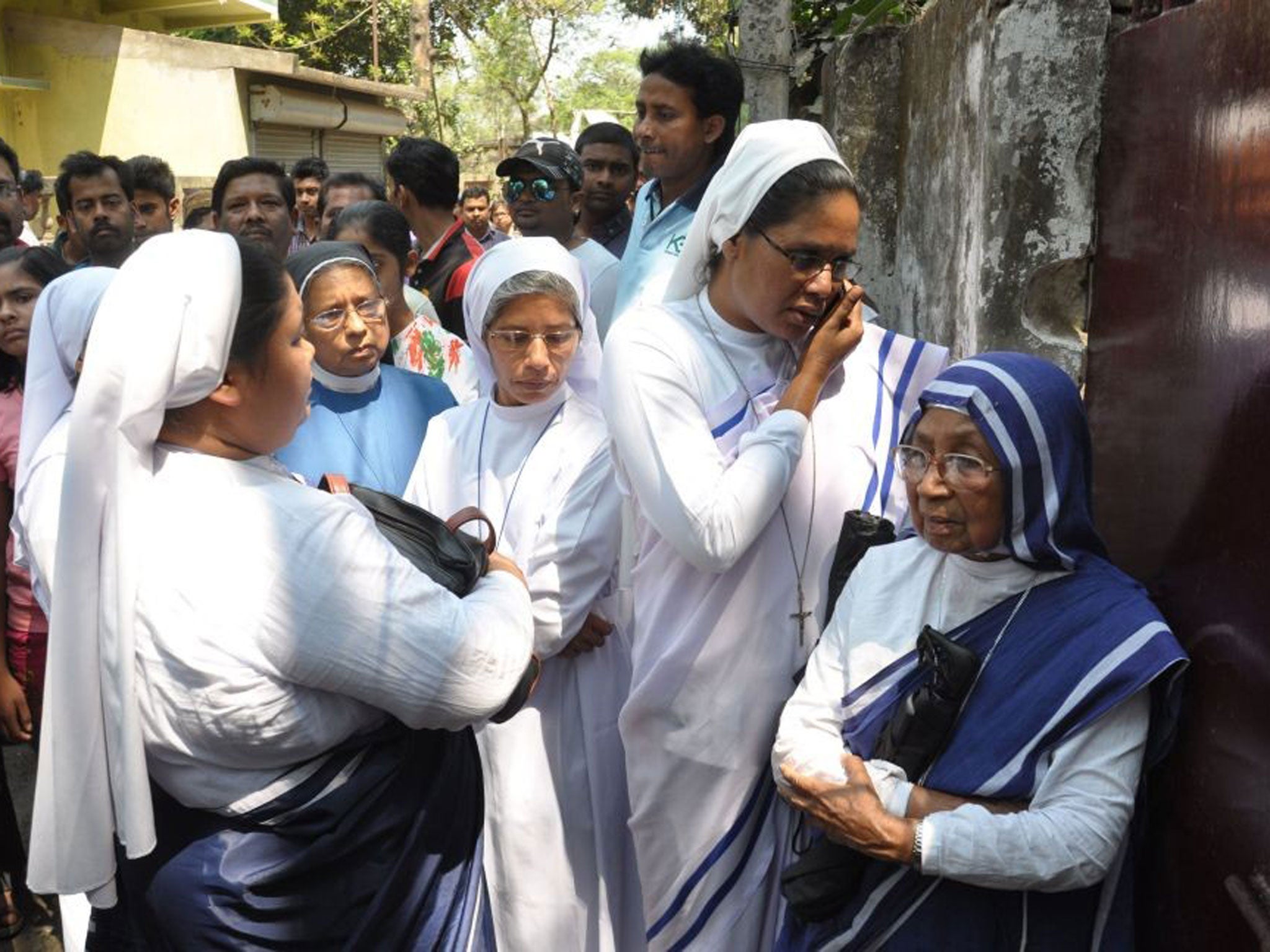 Christians nuns stand next to the attacked convent in Ranaghat as investigations continued into the gang-rape of a nun