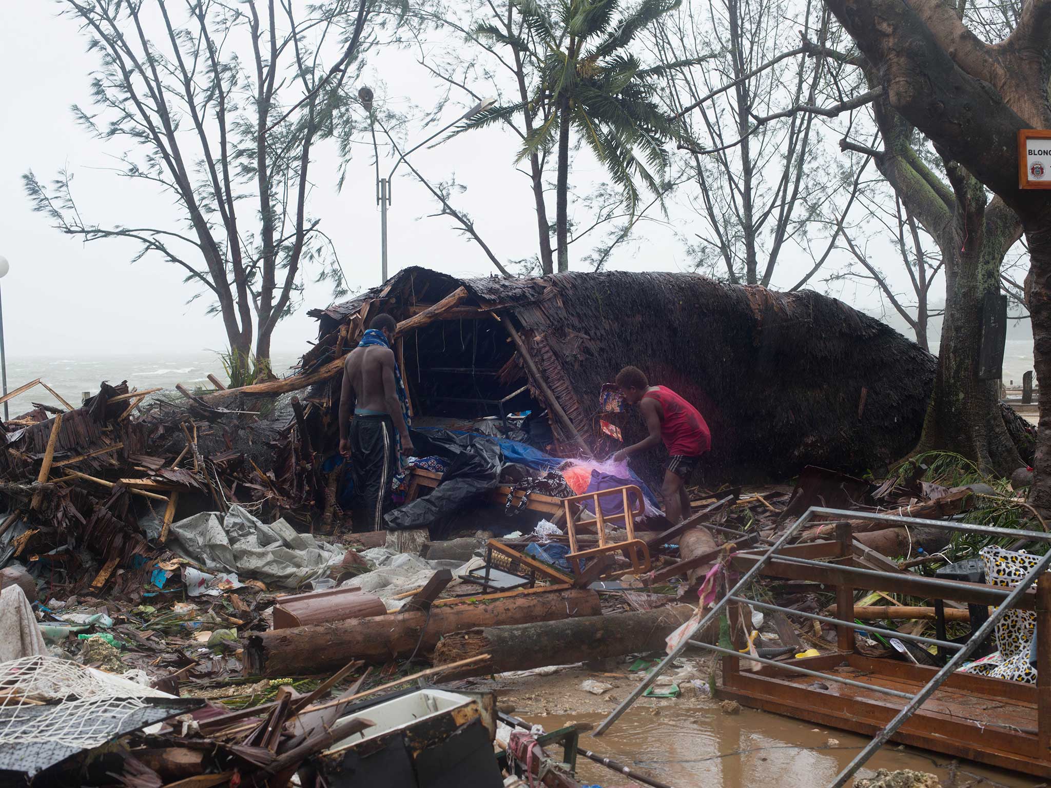 Survivors pick through the wreckage after Cyclone Pam