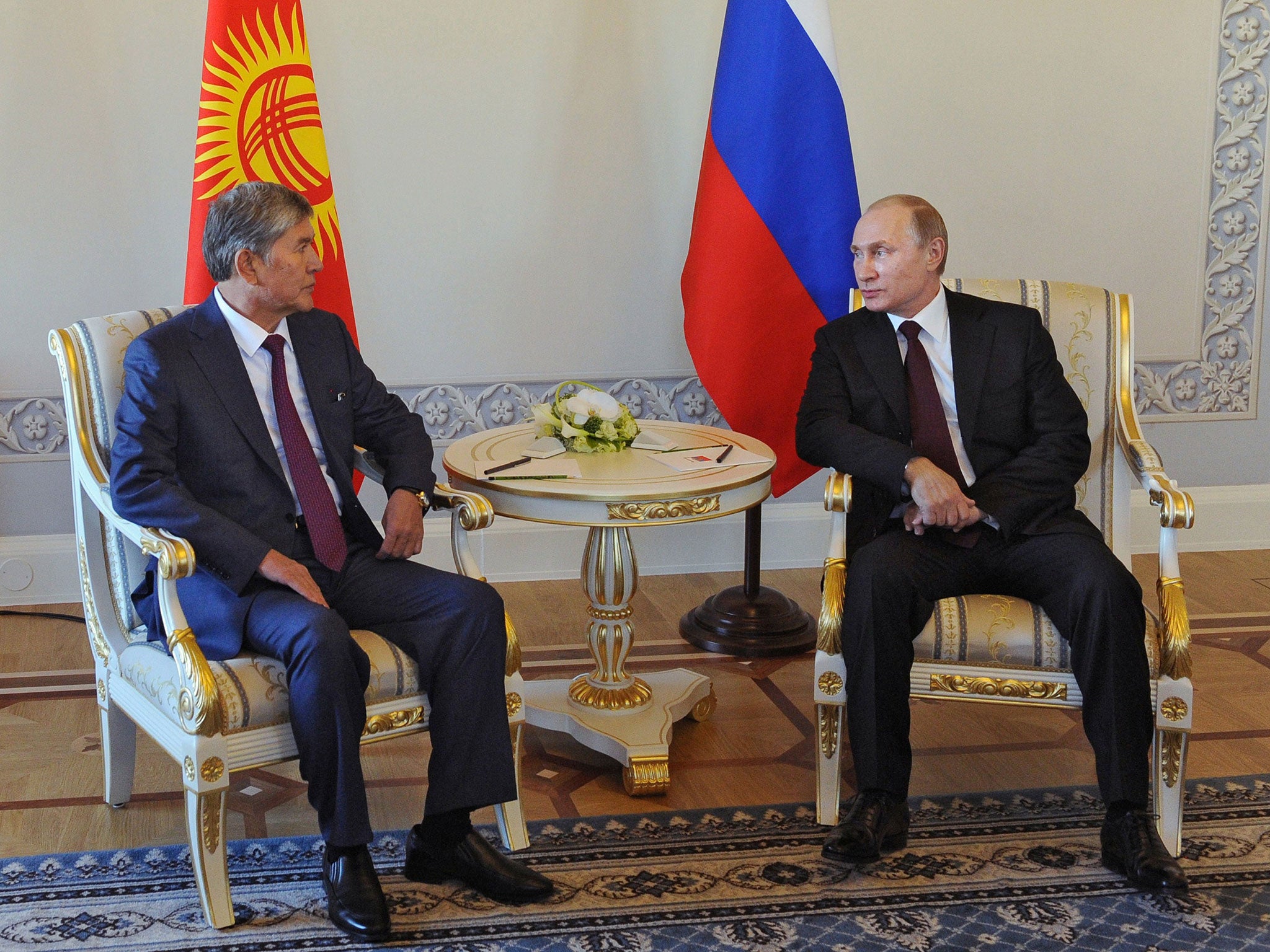 Russian President Vladimir Putin and his Kyrgyz counterpart Almazbek Atambayev attend a meeting in Saint Petersburg