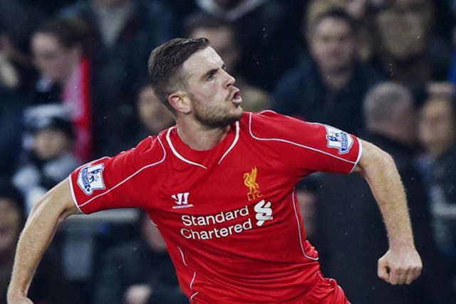 Jordan Henderson celebrates scoring Liverpool’s deflected winner in the 1-0 victory at Swansea City on Monday night