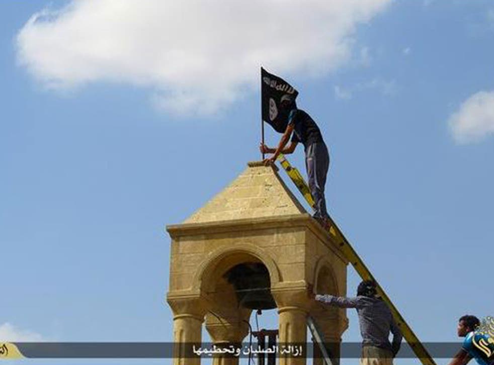 An Isis flag is placed on top of a structure 