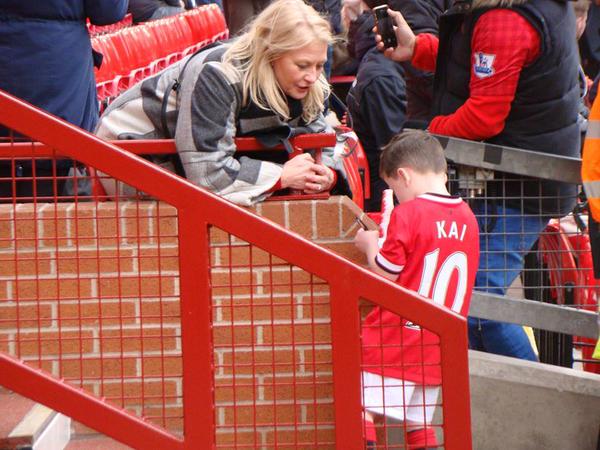 A fan asks Kai Rooney for his autograph