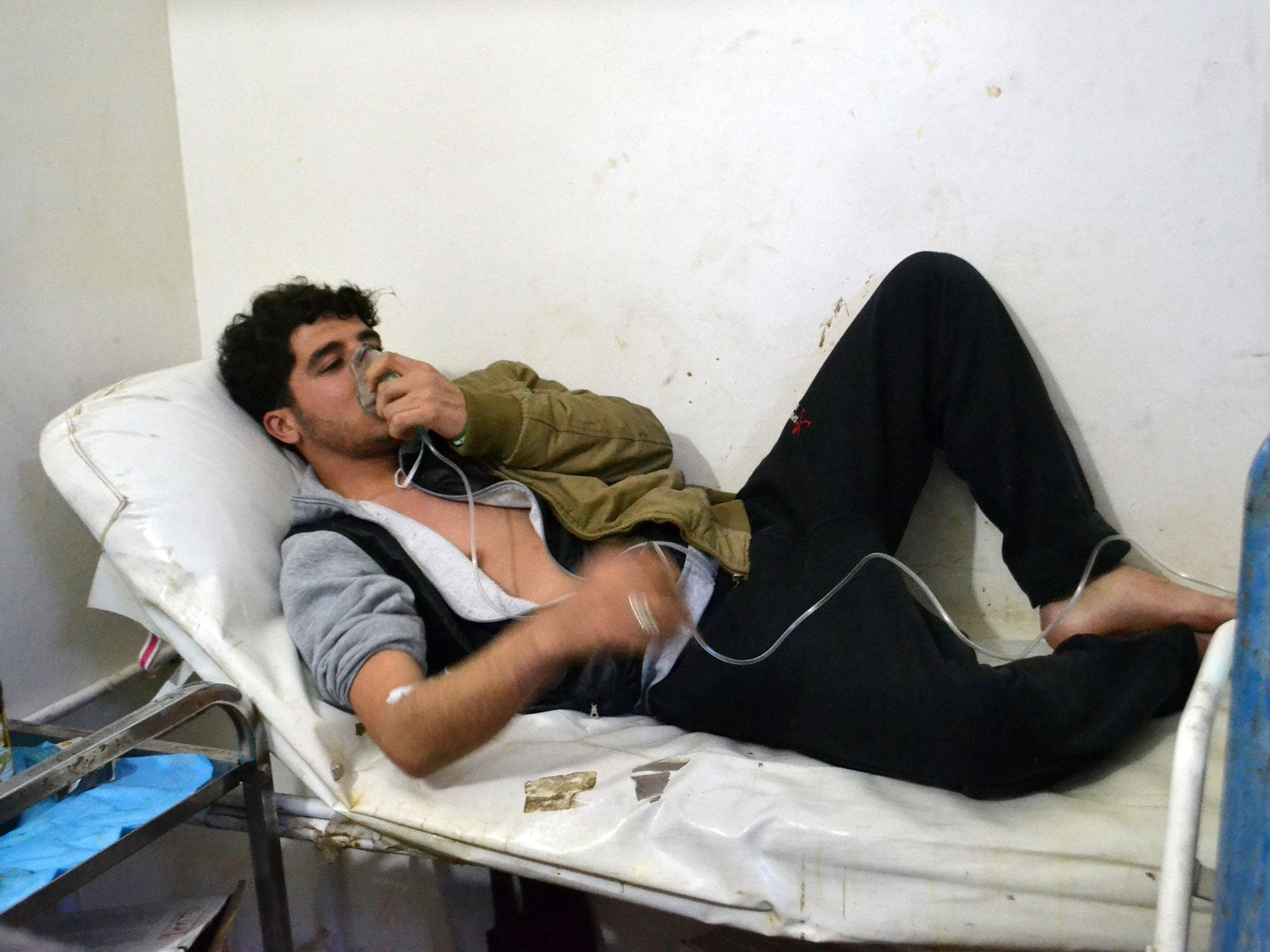 A young man breathes with an oxygen mask on March 17, 2015 at a clinic in the village of Sarmin