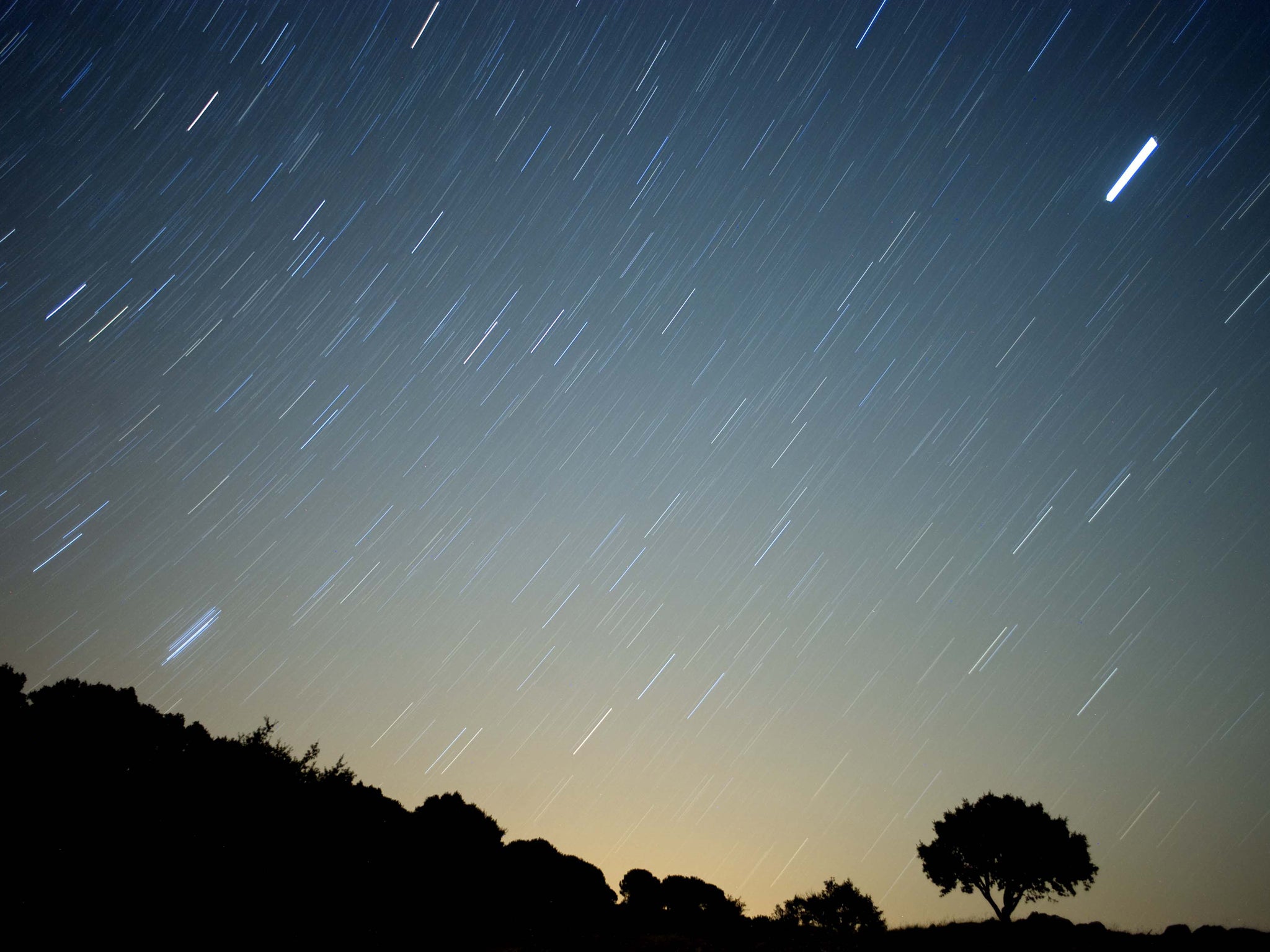 A meteor streaks across the sky against a field of stars during a meteorite shower early August 13, 2010 near Grazalema, southern Spain