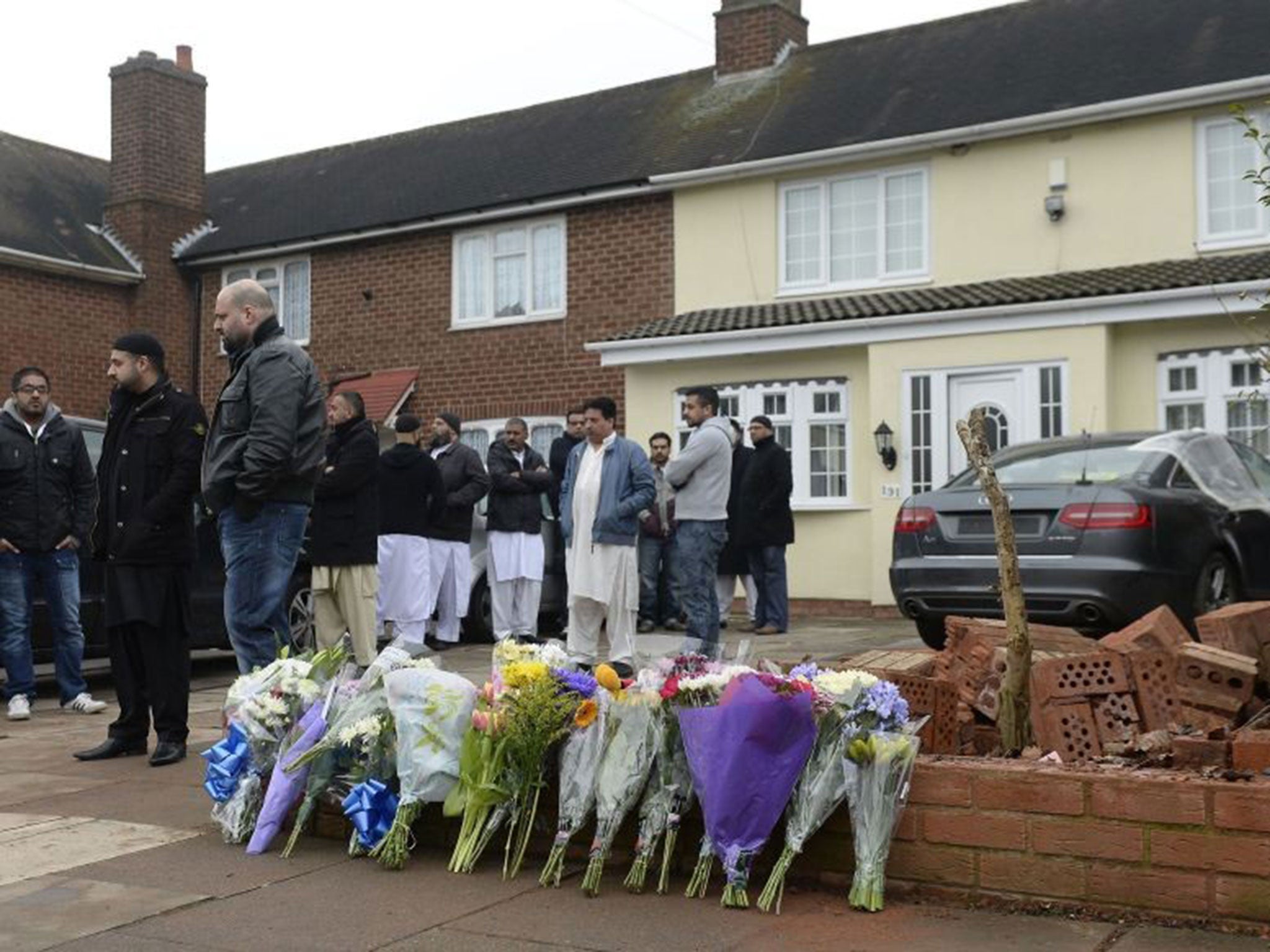 Flowers were left outside the home as friends and family gathered to express their condolences today