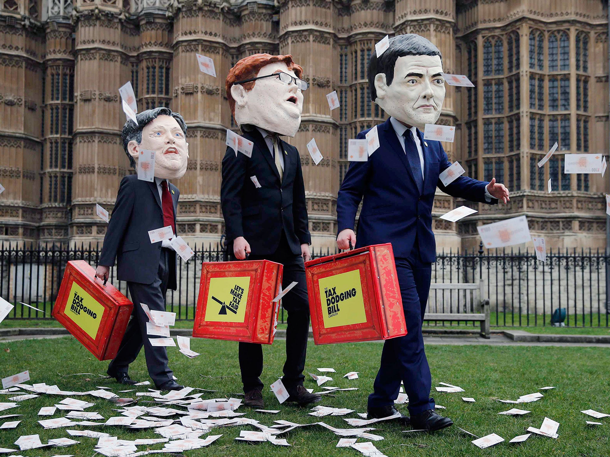 Campaigners from the Tax Dodging Bill campaign dressed up as Britain's shadow Chancellor of the Exchequer Ed Balls, Chief Secretary to the Treasury Danny Alexander, and Chancellor of the Exchequer George Osborne (L-R), participate in a publicity stunt acr
