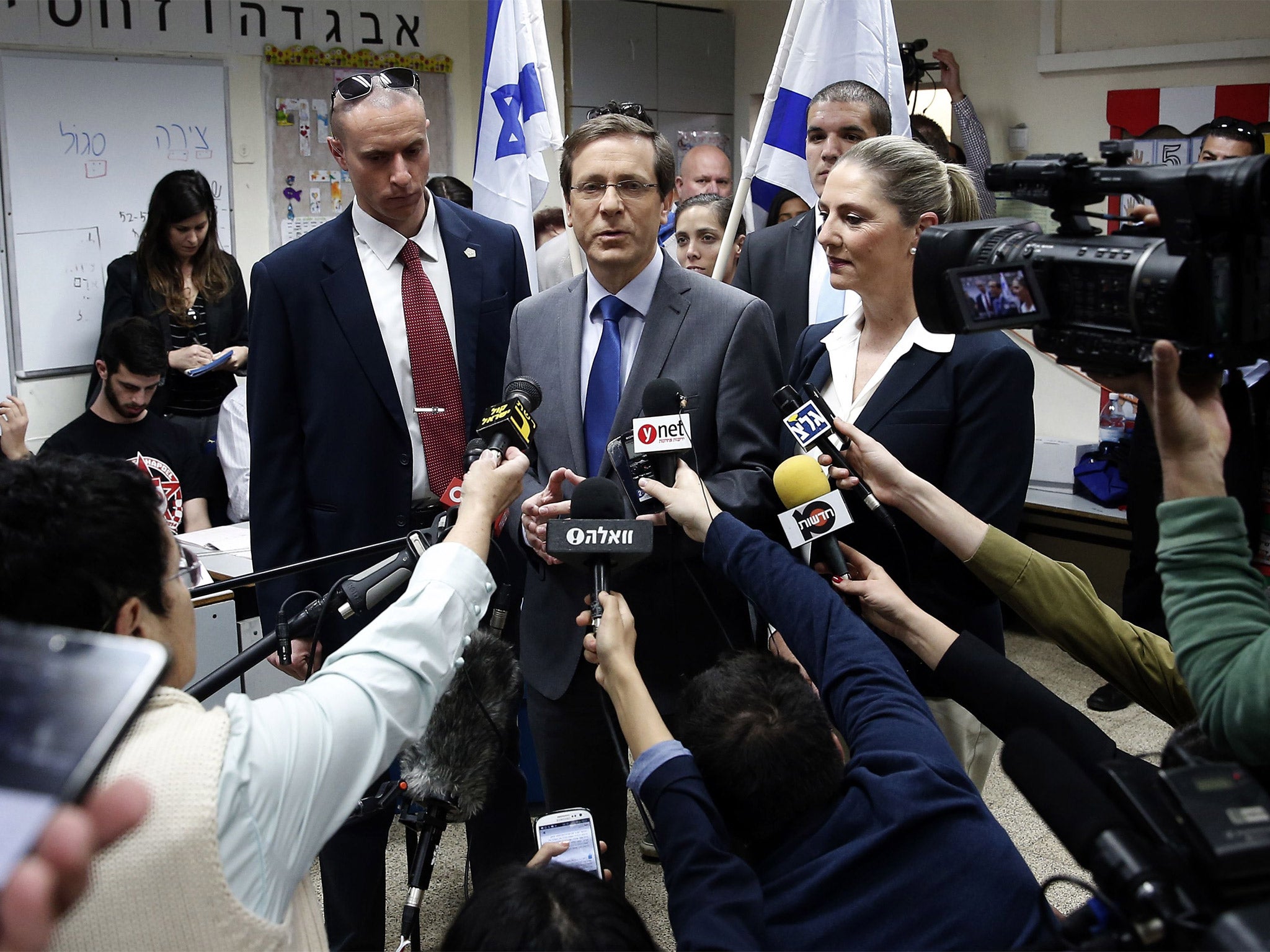 Isaac Herzog, the Labour Party and Zionist Union leader, with his wife Michal, talks to the media after voting in Tel Aviv (Getty)