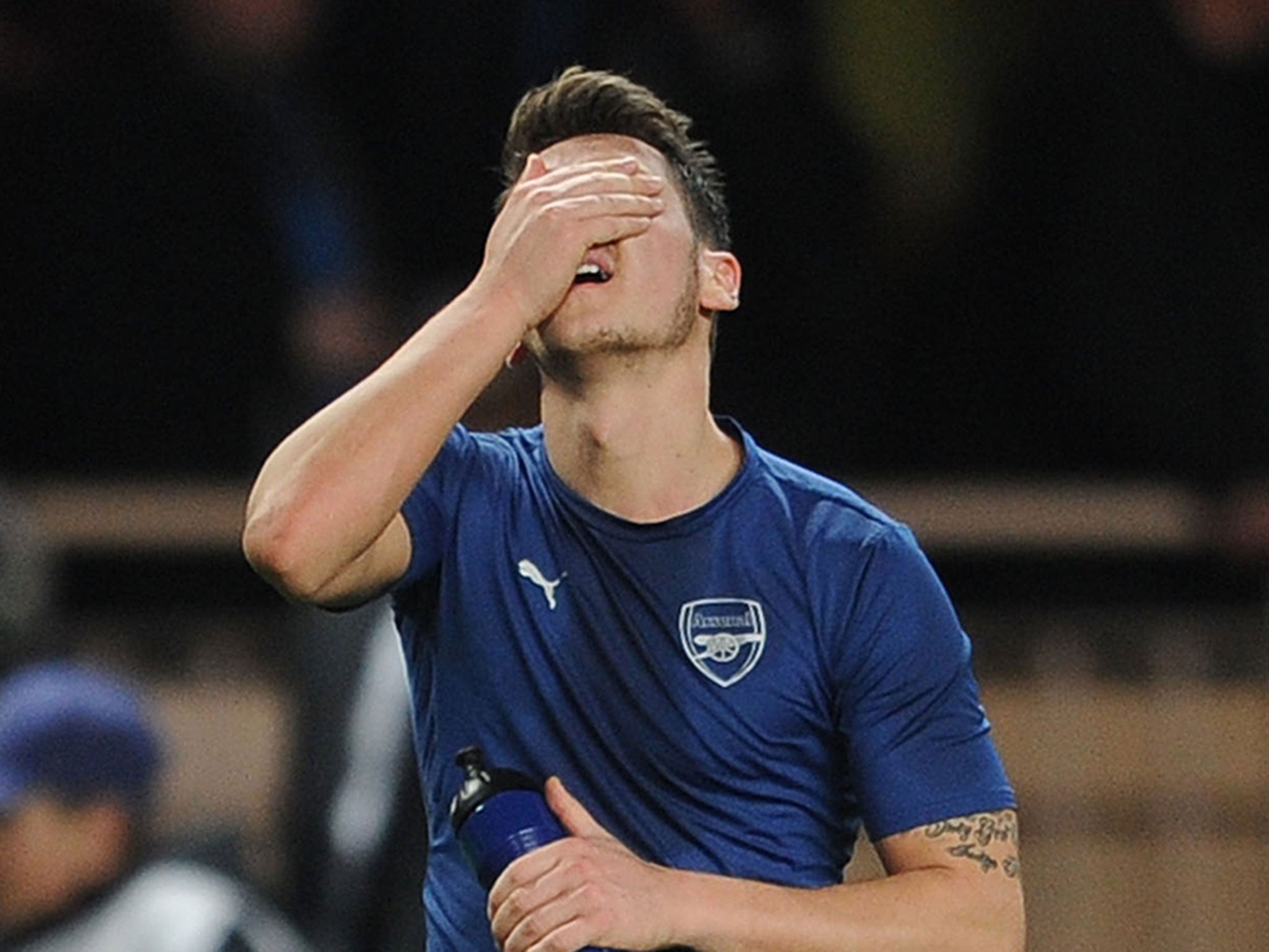 A distraught Mesut Ozil reacts after Arsenal were knocked out of the Champions League on Wednesday