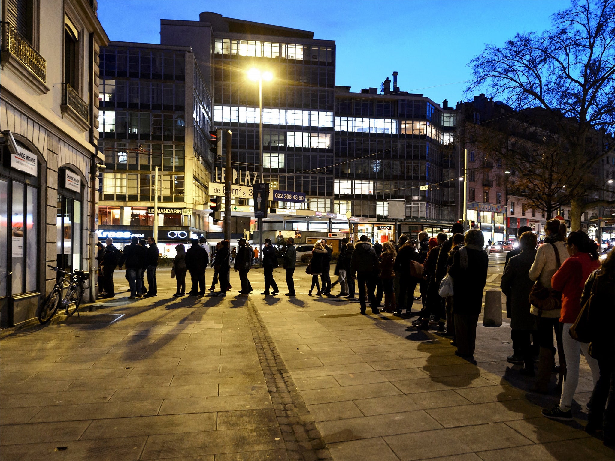 People queue at a currency exchange office in Geneva on 15 January, after the shock move by Switzerland’s central bank 