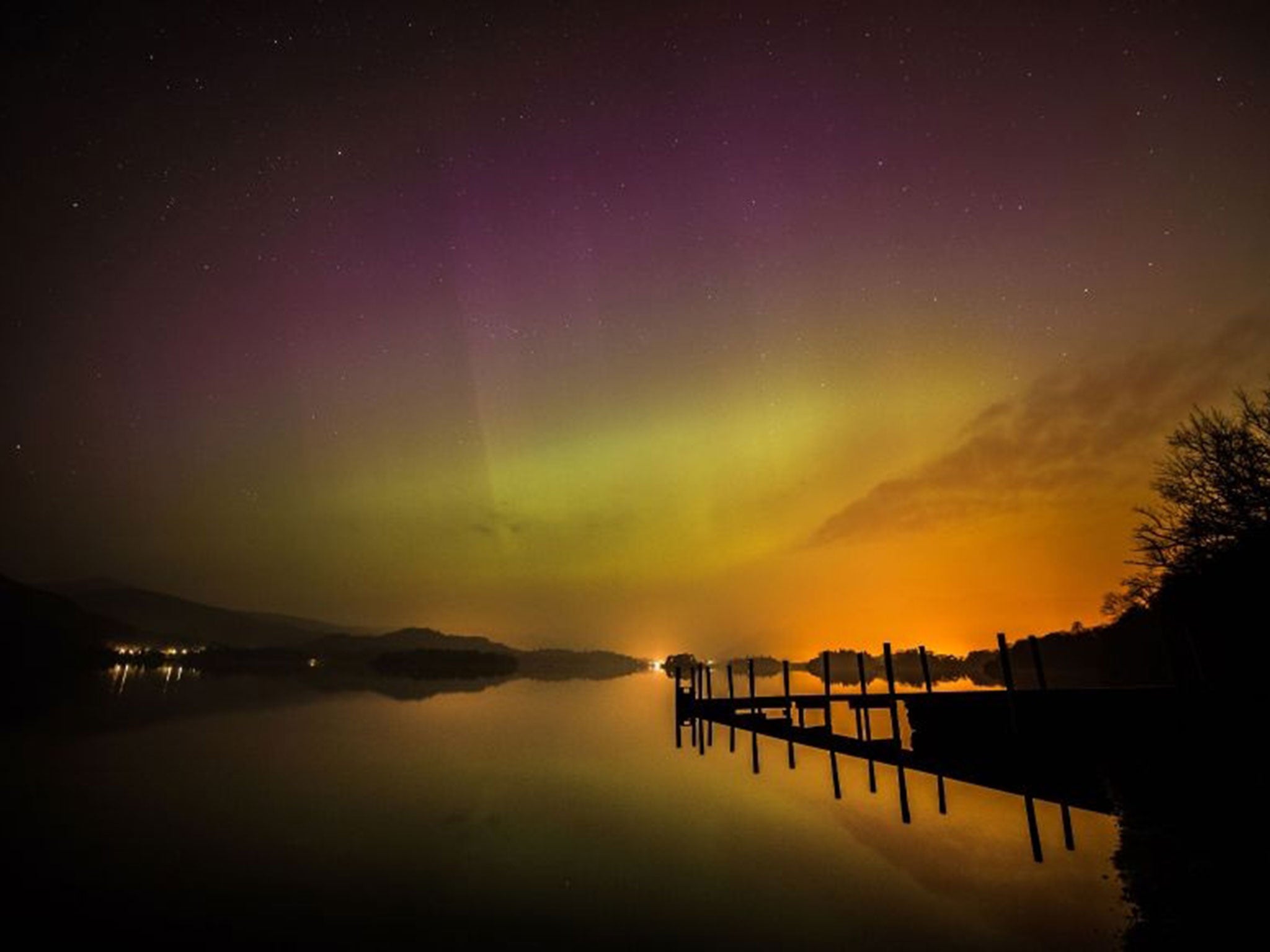 The aurora borealis, or the northern lights as they are commonly known, over Derwent water near Keswick in the Lake District.