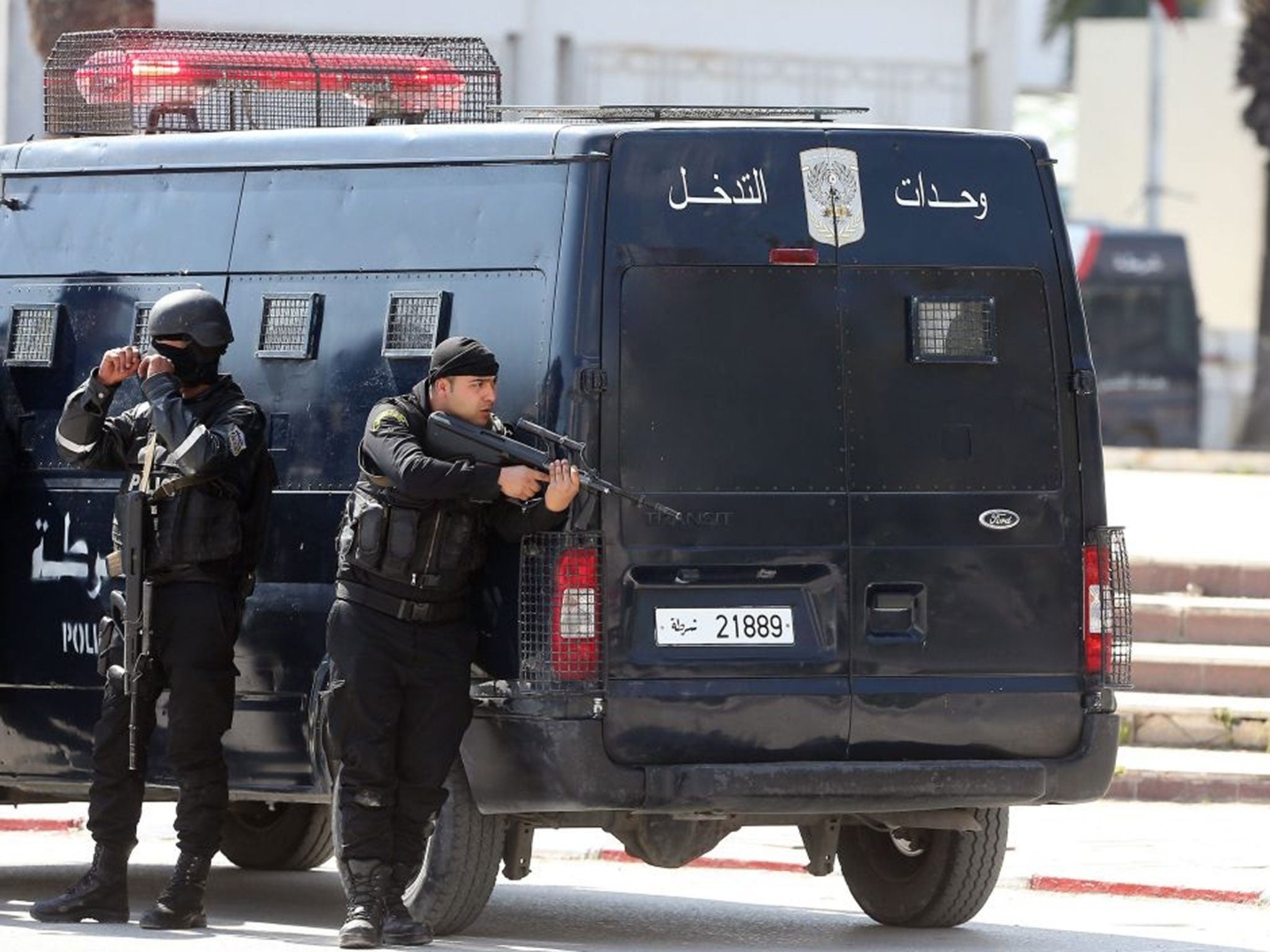 Police officers are seen on the pavement outside parliament in Tunis