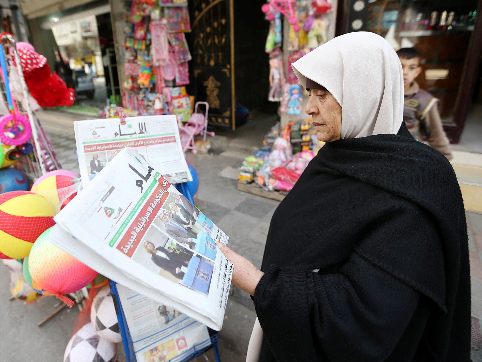 A Palestinian in Gaza reads about Israel’s election