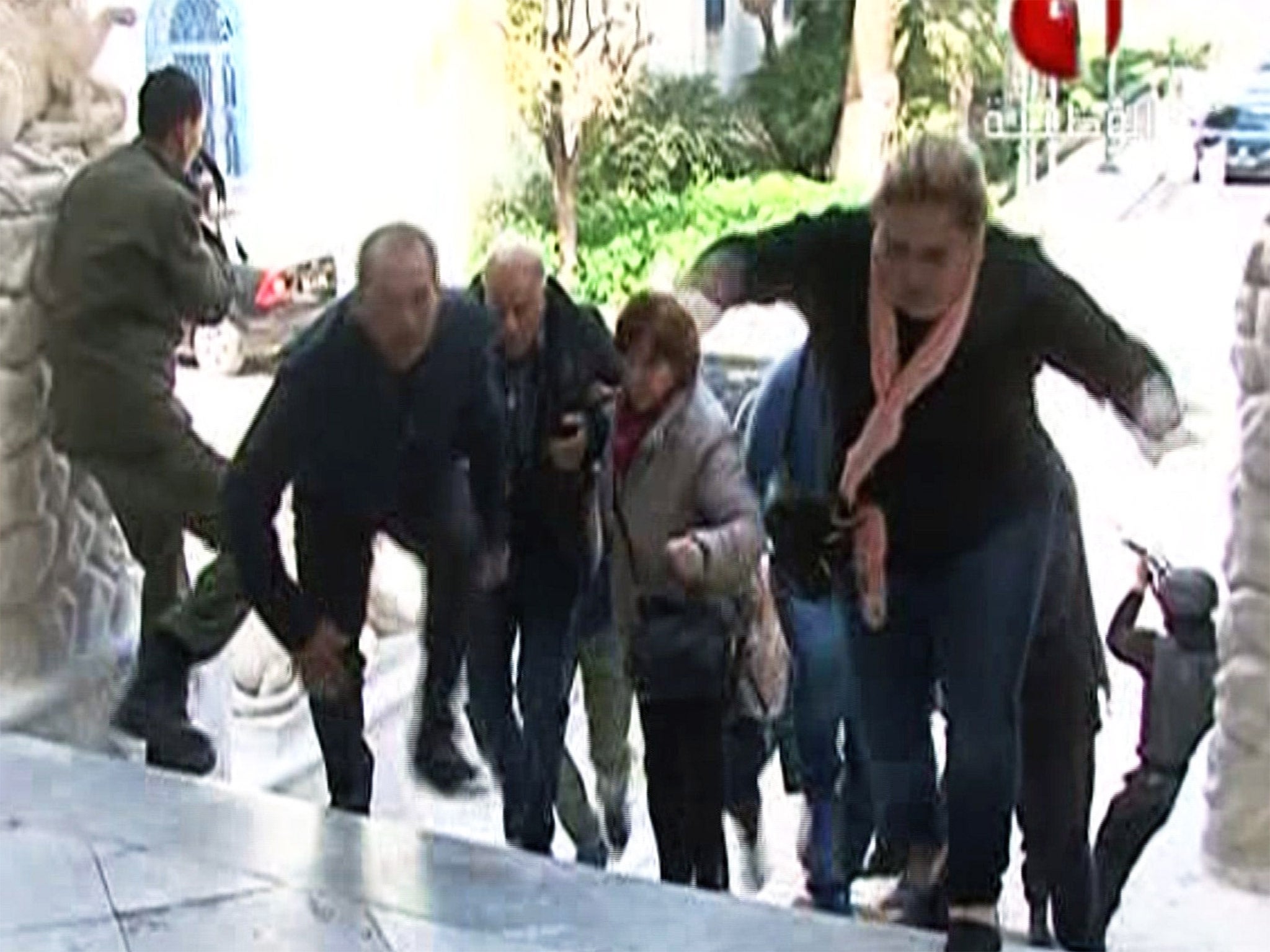 People make their escape from the Bardo Museum in Tunis during an attack by men armed with assault rifles