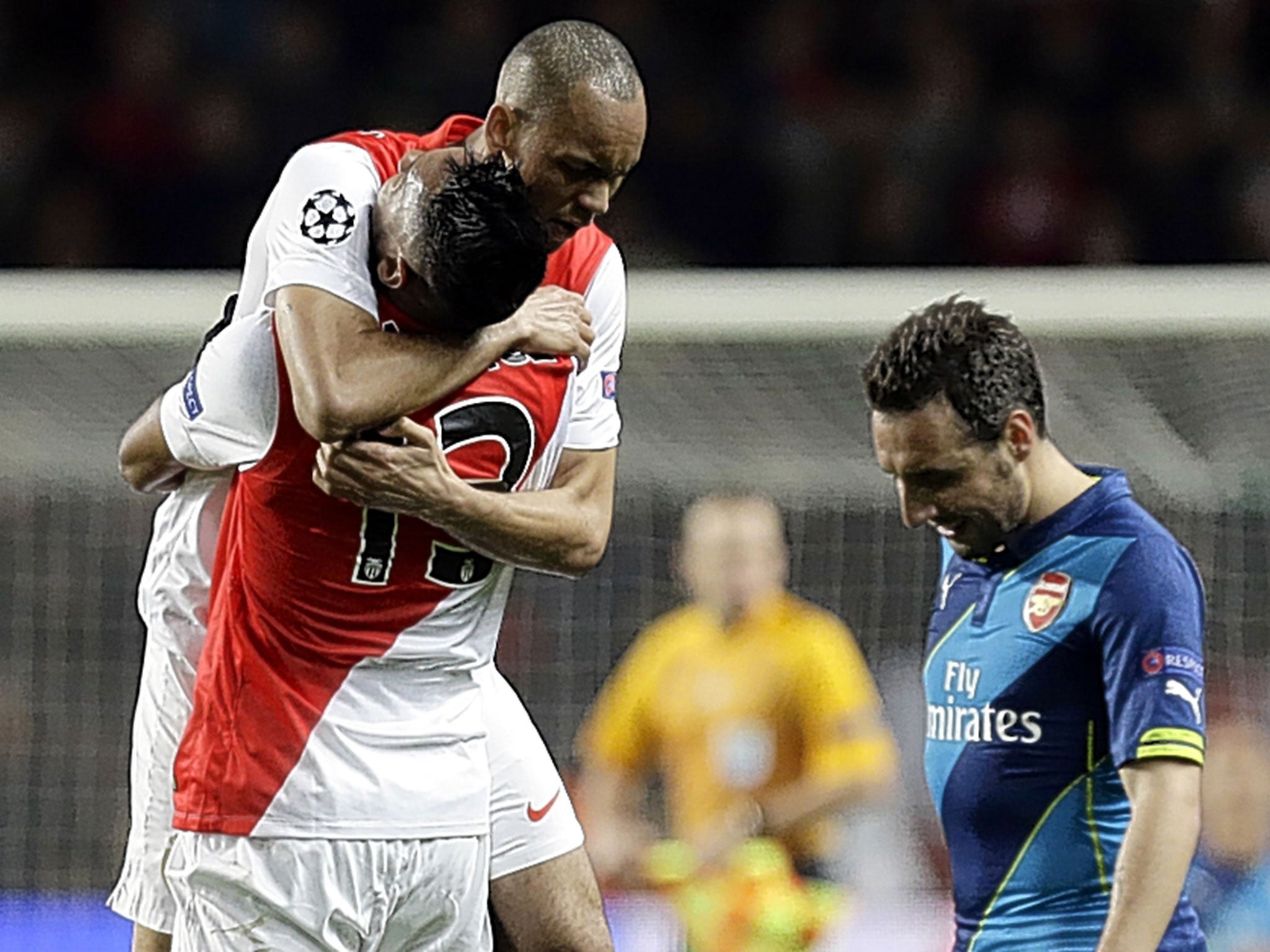 Arsenal's Santi Cazorla is downcast at the final whistle as Monaco players celebrate