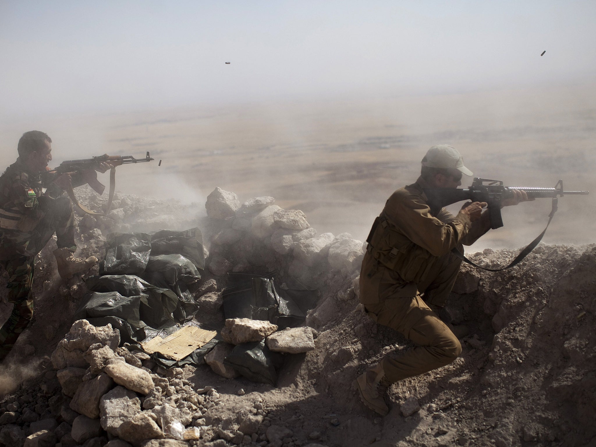 Iraqi Kurdish Peshmerga fighters fire at Islamic State