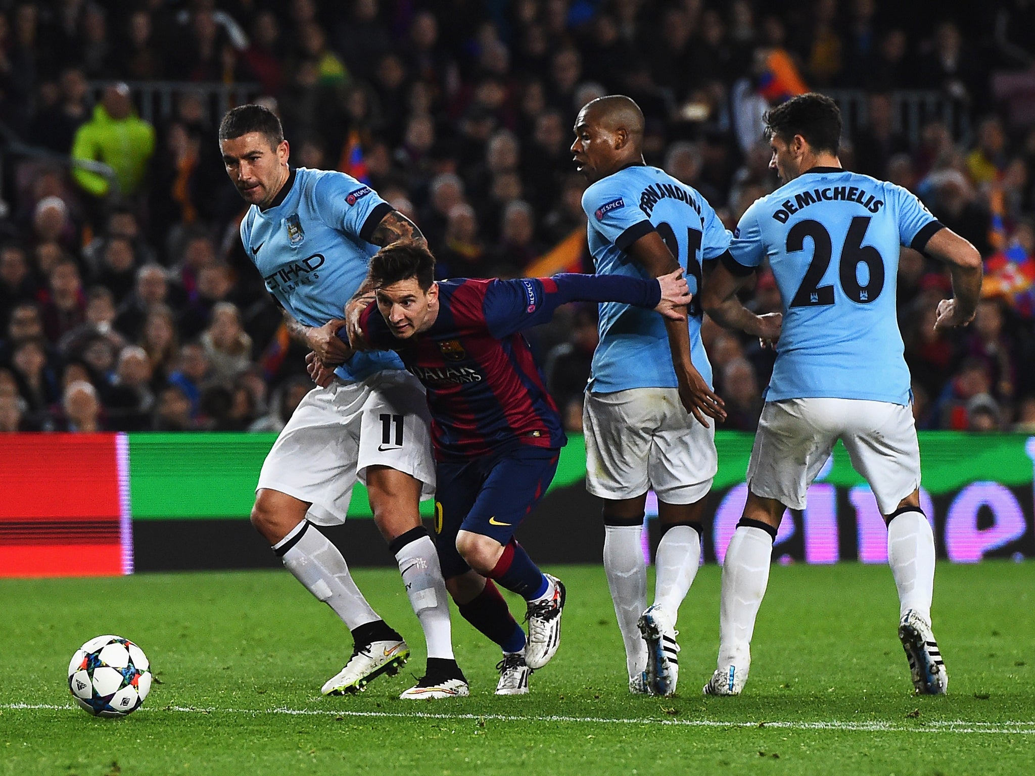 Lionel Messi, of Barcelona, breaks past Aleksandar
Kolarov, Fernandinho and Martin Demichelis, of
Manchester City, to the delight of the Nou Camp