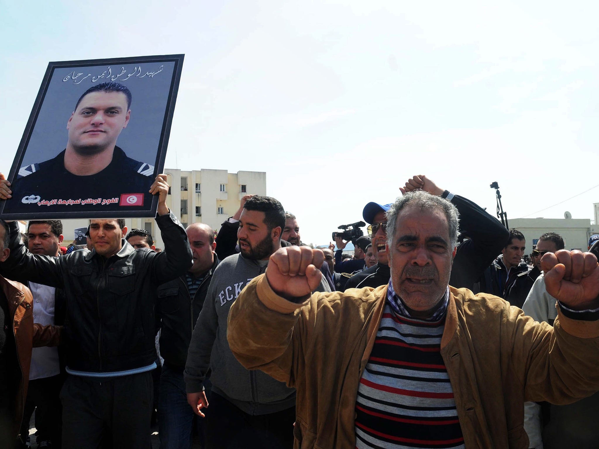 Mourners gather during the funeral for Tunisian police officer Ayman Morgani