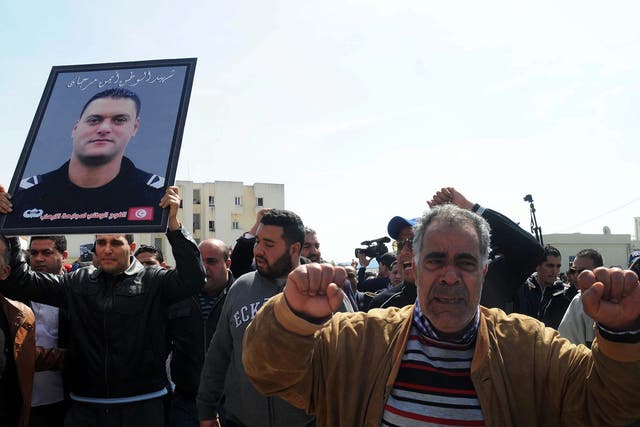 Mourners gather during the funeral for Tunisian police officer Ayman Morgani